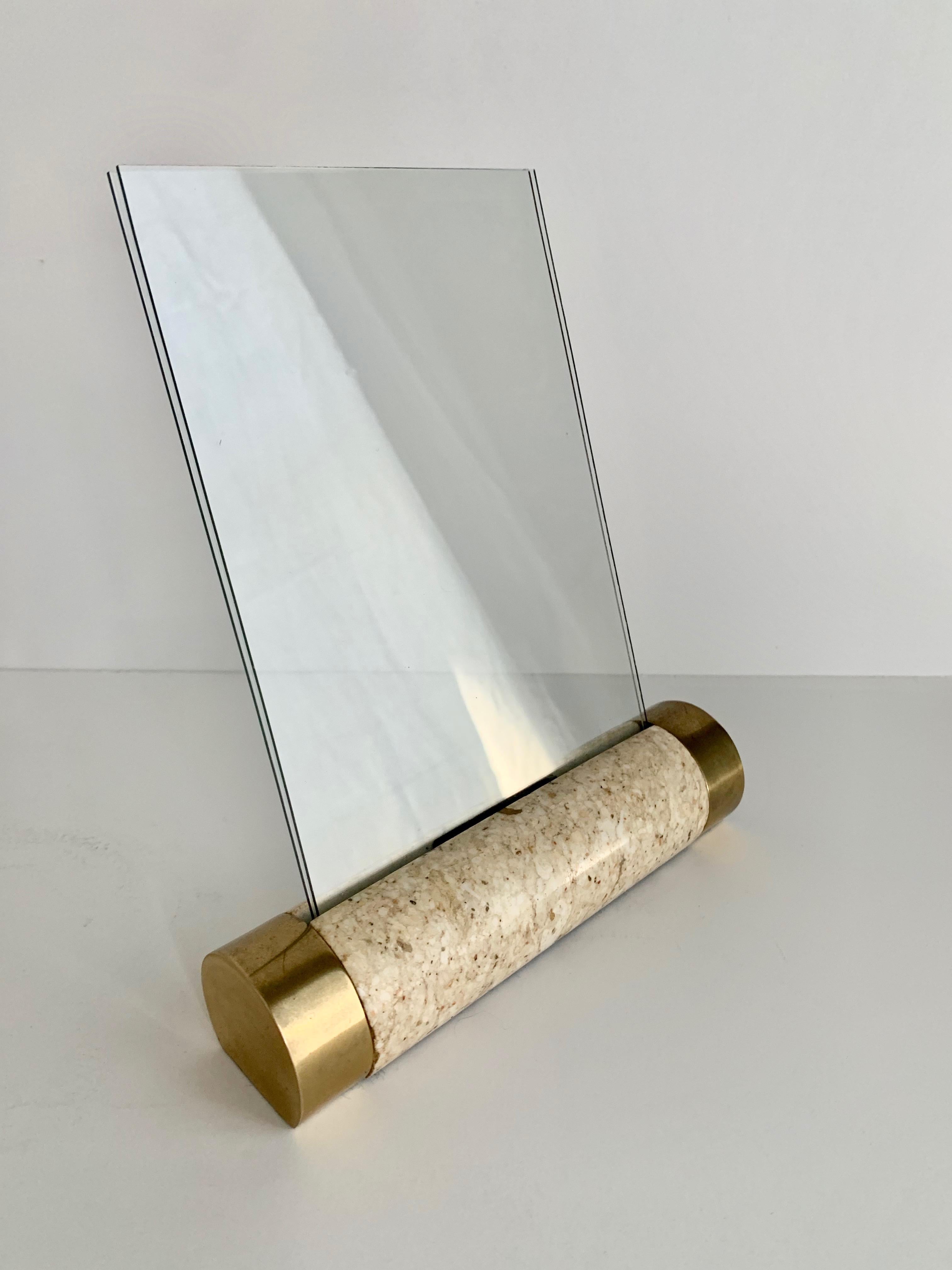 Tessellated marble solid cylinder with brass detailing on each end, the cylinder holds a two pieces of glass that together hold a photo in the format of 5 x 7. A wonderfully modern photo frame in the manner of Maitland Smith with midcentury style