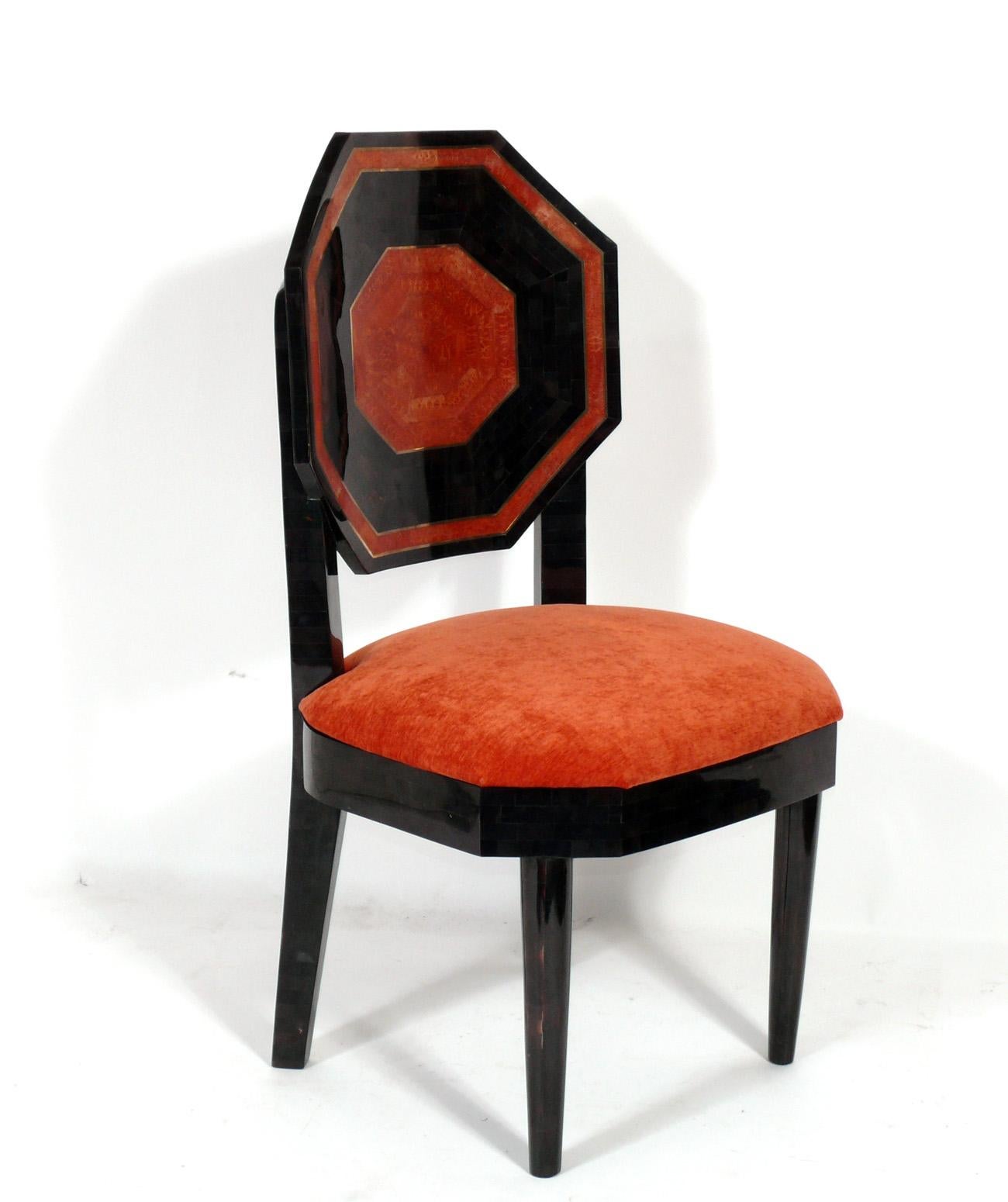 Tessellated Marble Dining Chairs, American, circa 1970s. Outstanding color combination with the black and deep coral orange color tessellated marble with inset brass inlay. Newly reupholstered in a plush velvety fabric.