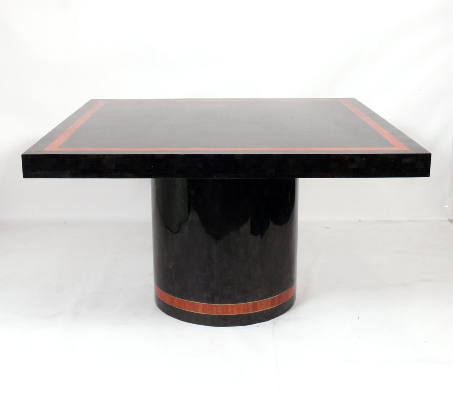 Tessellated marble dining table, American, circa 1970s. Outstanding color combination with the black and deep coral orange color tessellated marble with inset brass inlay. Thick substantial tabletop and heavyweight construction. Please see our other