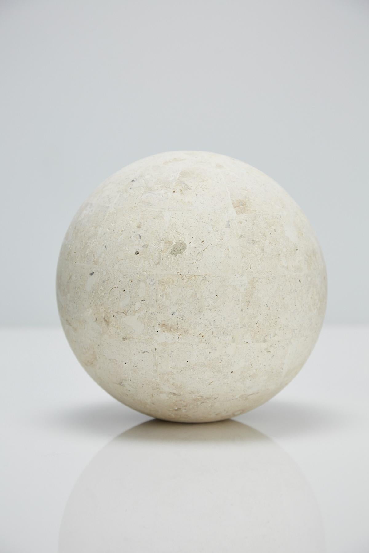 Postmodern tessellated stone sphere executed in matte Mactan stone over a fiberglass body. 

Measures: 7.5 in. diameter.

Pair available.

All furnishings are made from 100% natural Fossil Stone or Seashell inlay, carefully hand cut and crafted