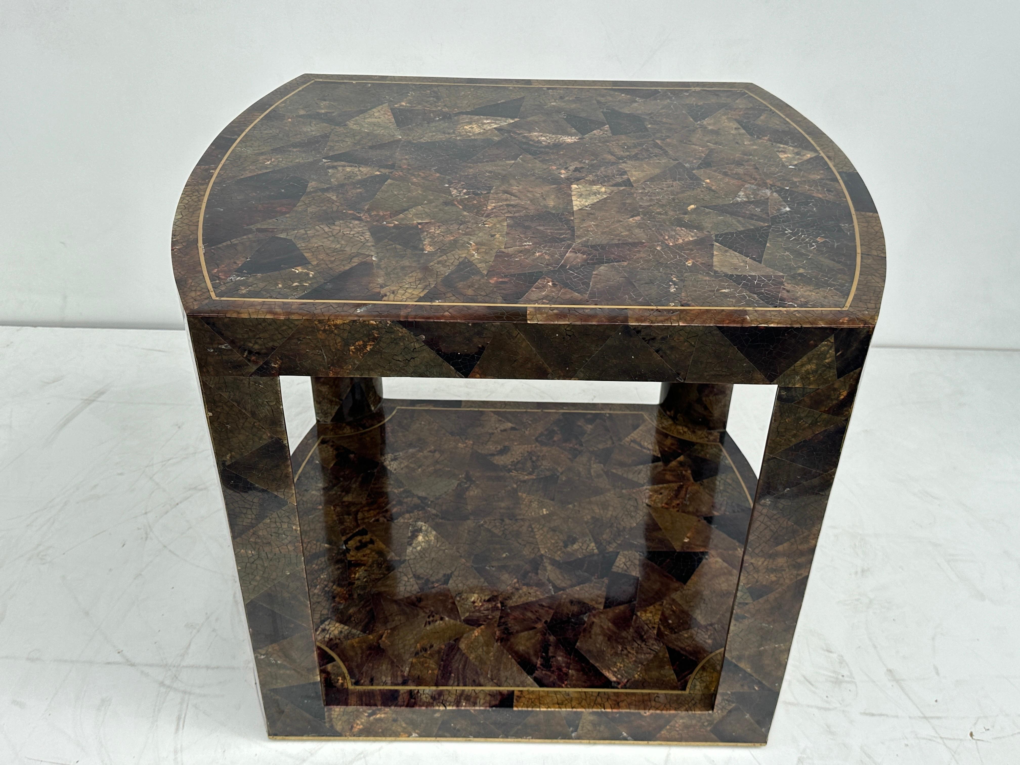 Tessellated pen shell side / end table with brass detailing. It is stamped Maitland Smith but we also seen exact same table stamped Karl Springer.