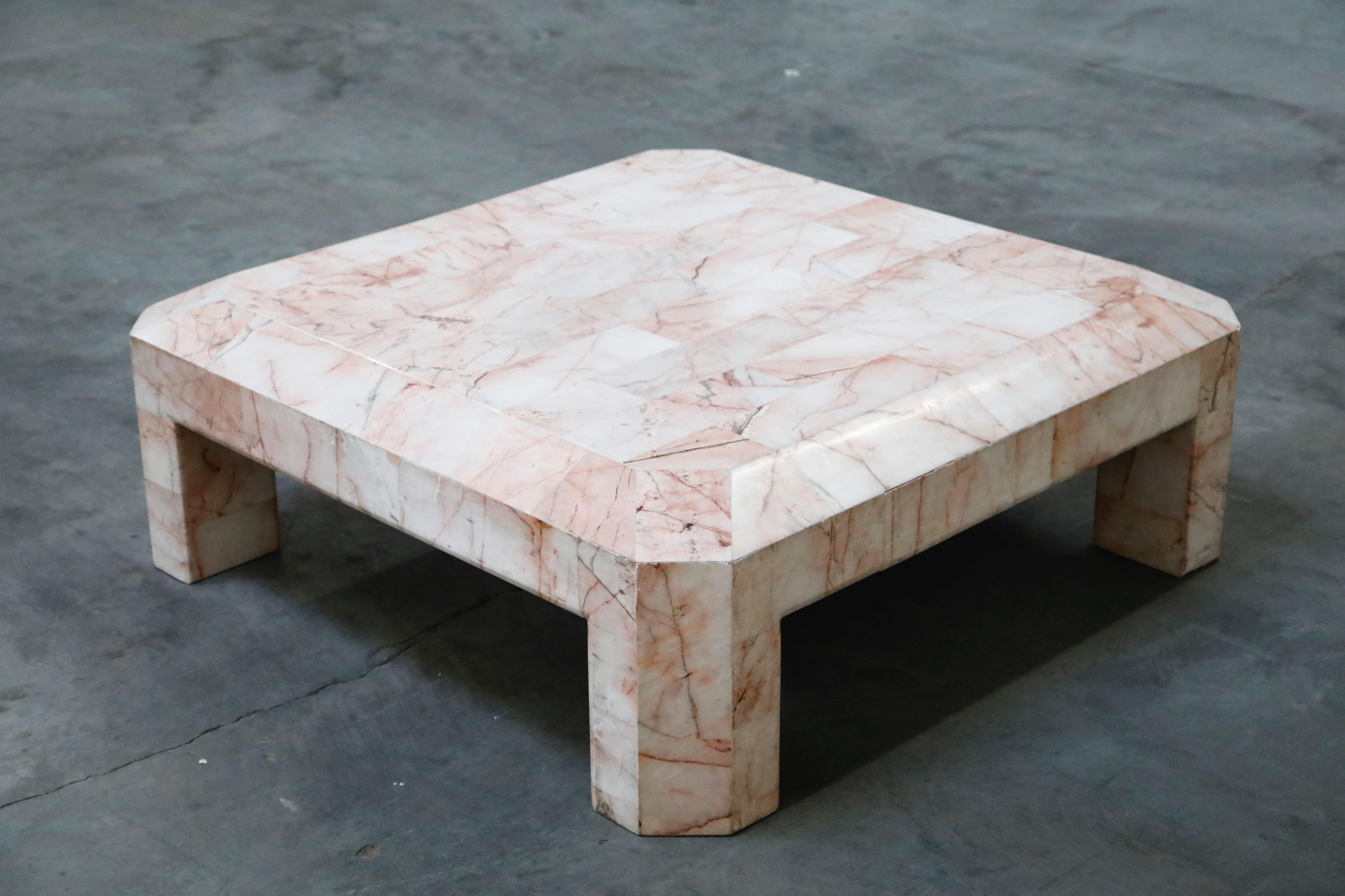 So gorgeous and designer on-trend, this heavy and substantial coffee table is constructed from tessellated pink onyx and even comes with a matching modern sculpture! The angled and architectural shape makes it perfect for a Postmodern room, while