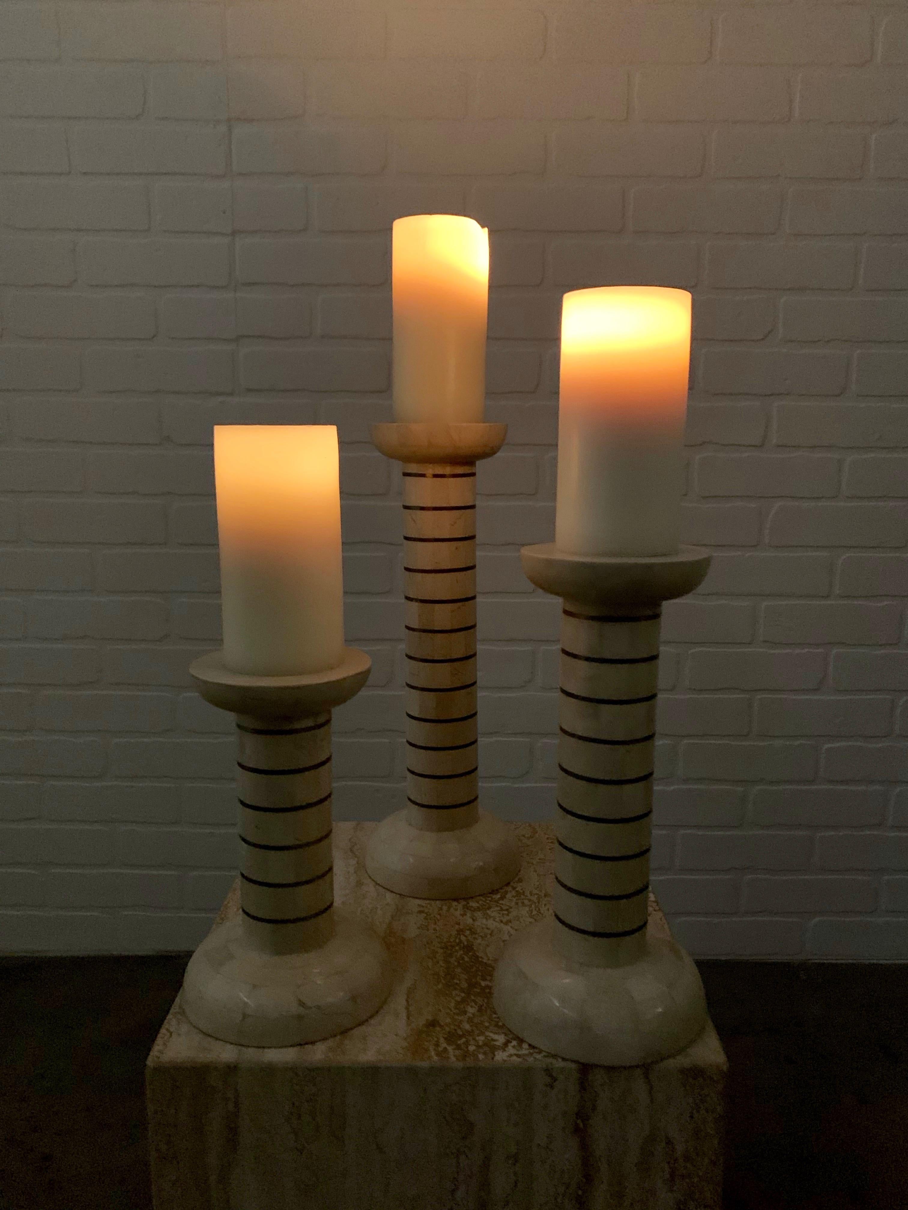 Vintage set of three candlesticks in the style of Maitland Smith. A combination of brass and stone
used candles are included if desired.