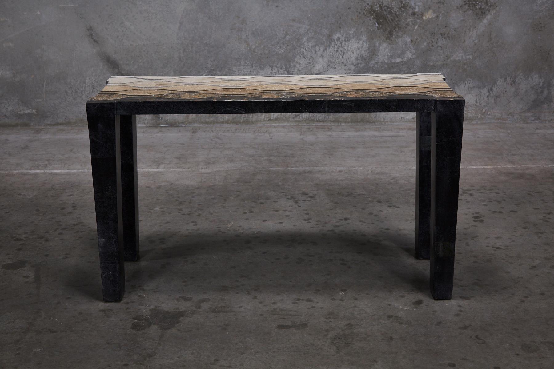 Simple rectilinear console table fully inlaid with tessellated stone. Legs in solid black stone. Tabletop inlaid with stylized wavy pattern executed in snakeskin stone, woodstone and cantor stone inlay. Handmade in the Philippines.

All furnishings