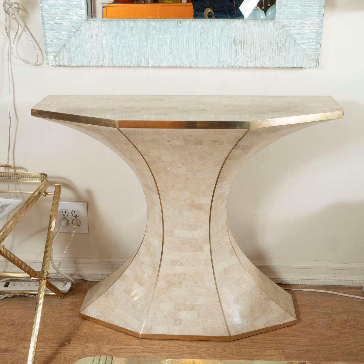 Tessellated stone demilune console with brass details.