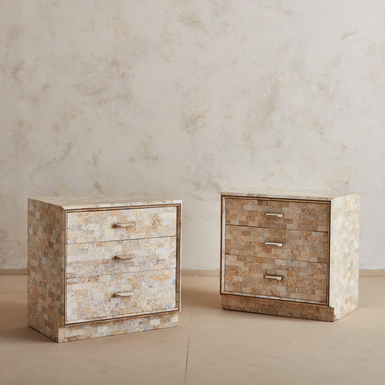 Gorgeous multi-colored tiles and unique hammered handles on this pair of tessellated stone nightstands by Maitland Smith. 

  