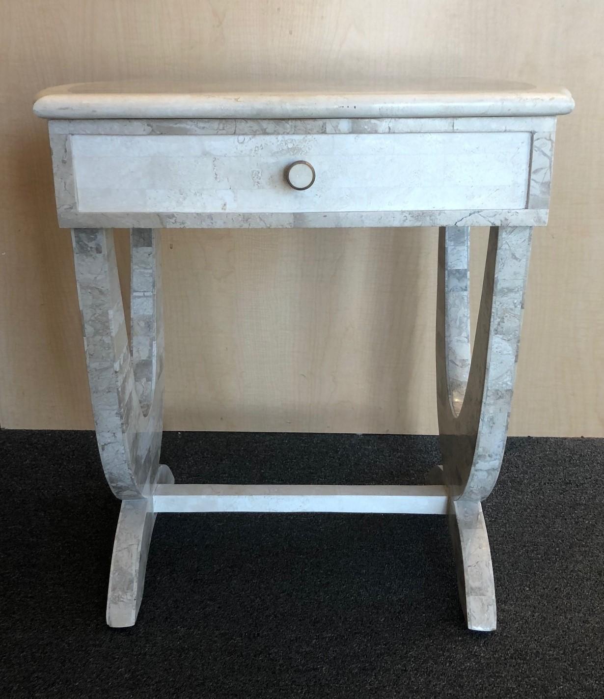 A very nice tessellated stone, one drawer side table circa 1990's. There is a small chip on the bottom of one of the legs of the table; please see pictures. Very functional and sturdy piece.