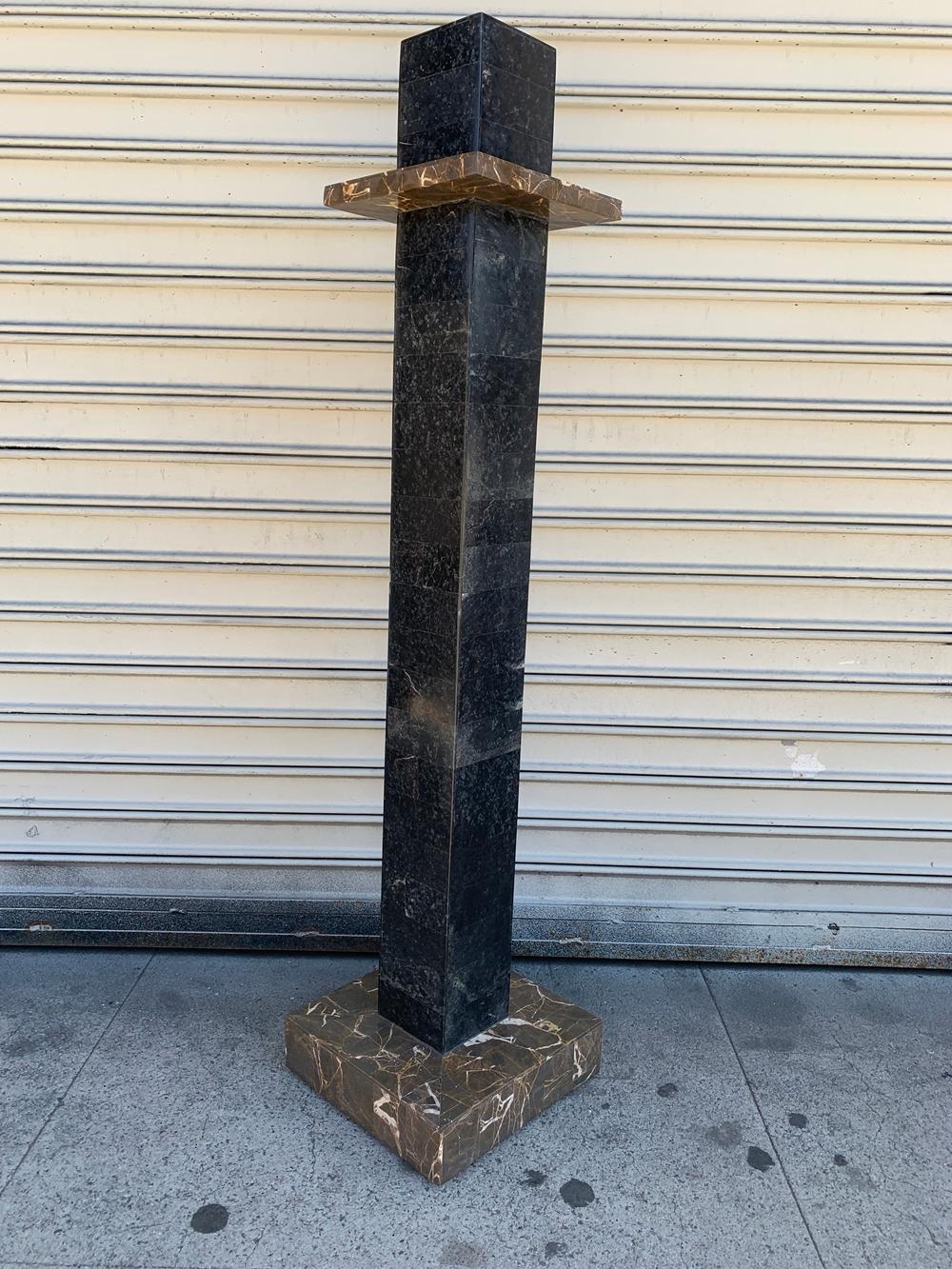 Beautiful pedestal in tessellated stone attb to Karl Springer.
The piece has beautiful architectural lines and are in very good condition.

Measurements:
42.5 high x 10 wide x 10 deep.