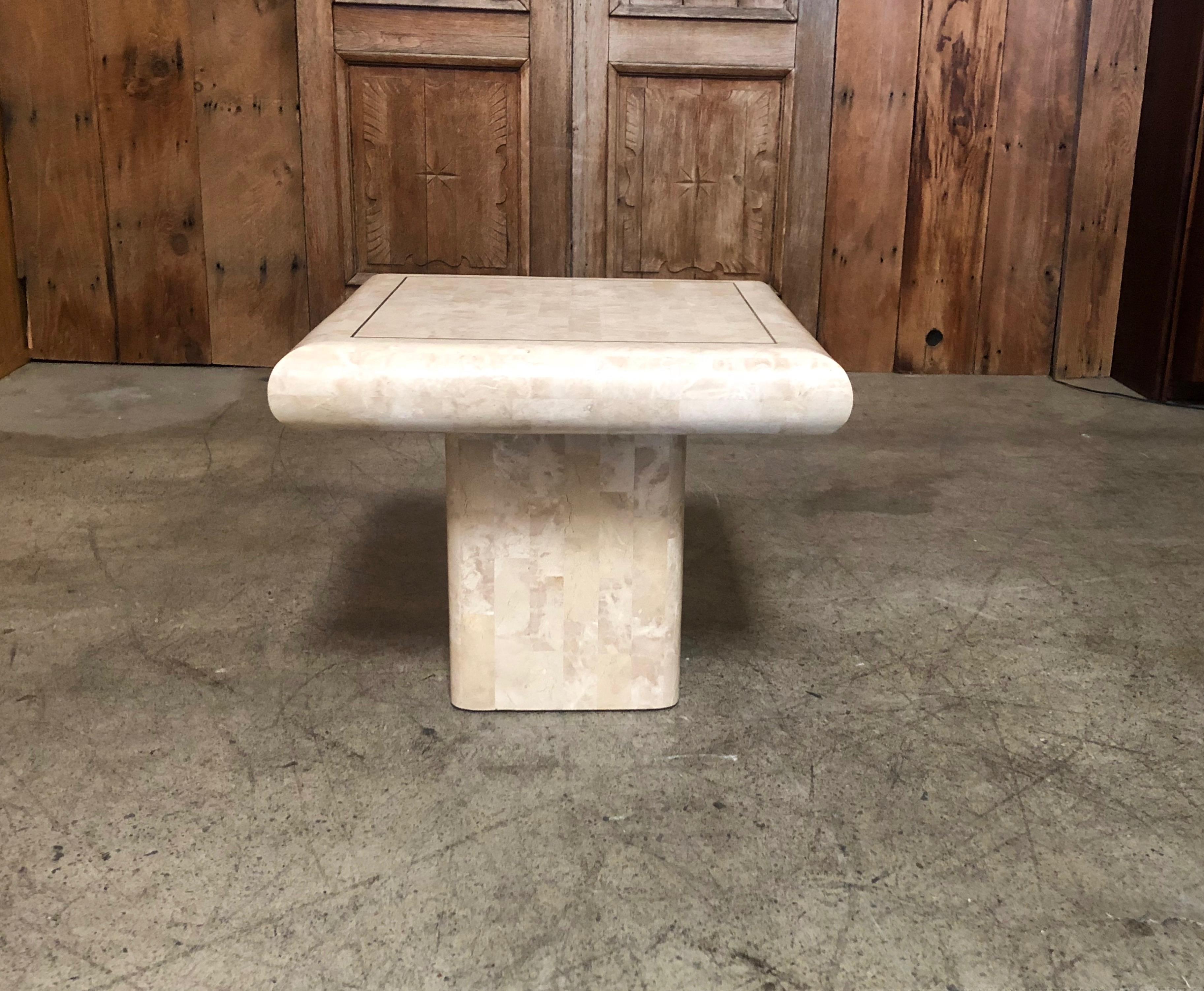 End table made of tessellated stone with brass inlay.