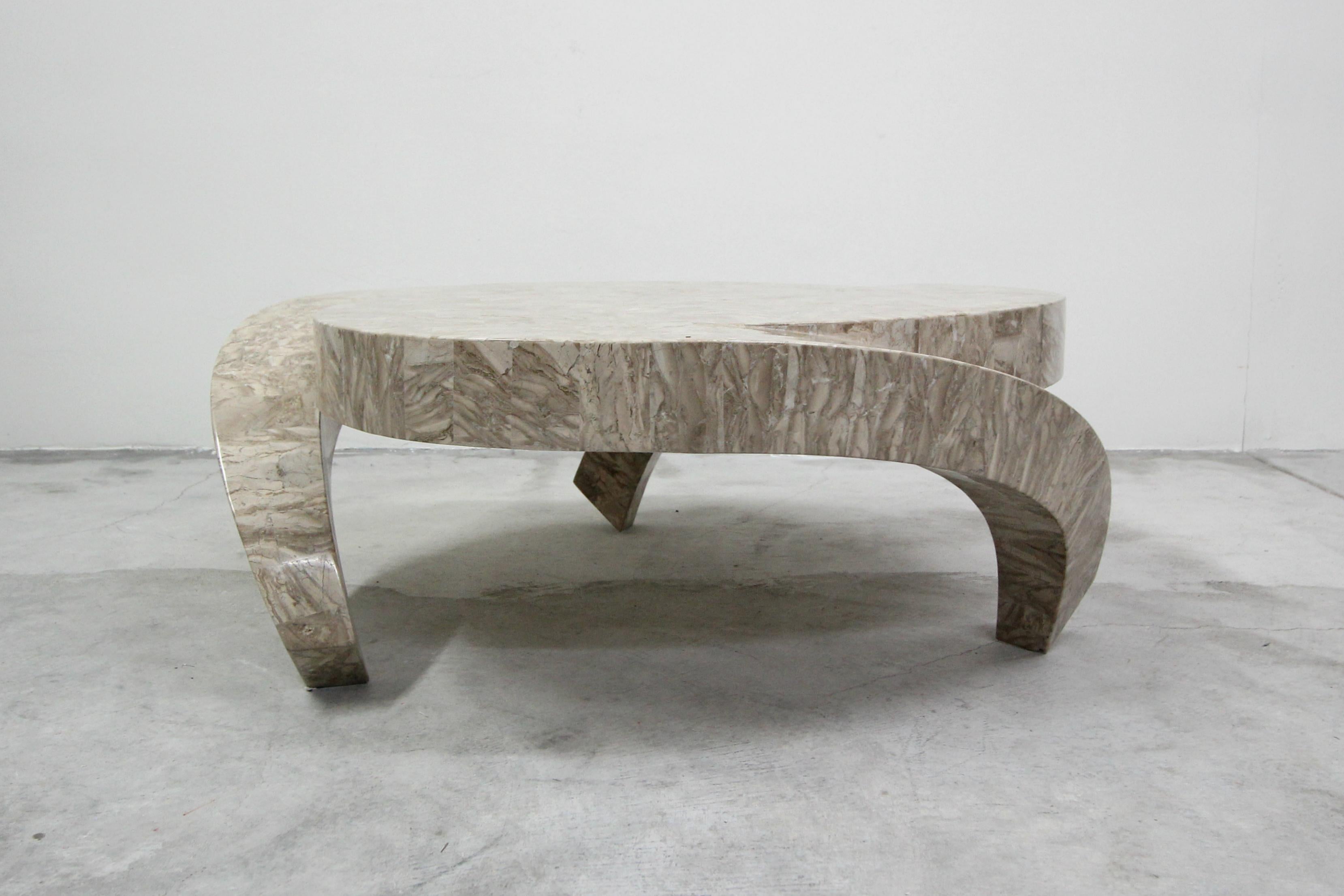 Unique tessellated stone coffee table by Maitland Smith. Table has a very eye-catching, trefoil shape, with three waterfall legs. Very designer, you'll likely never see another like it.