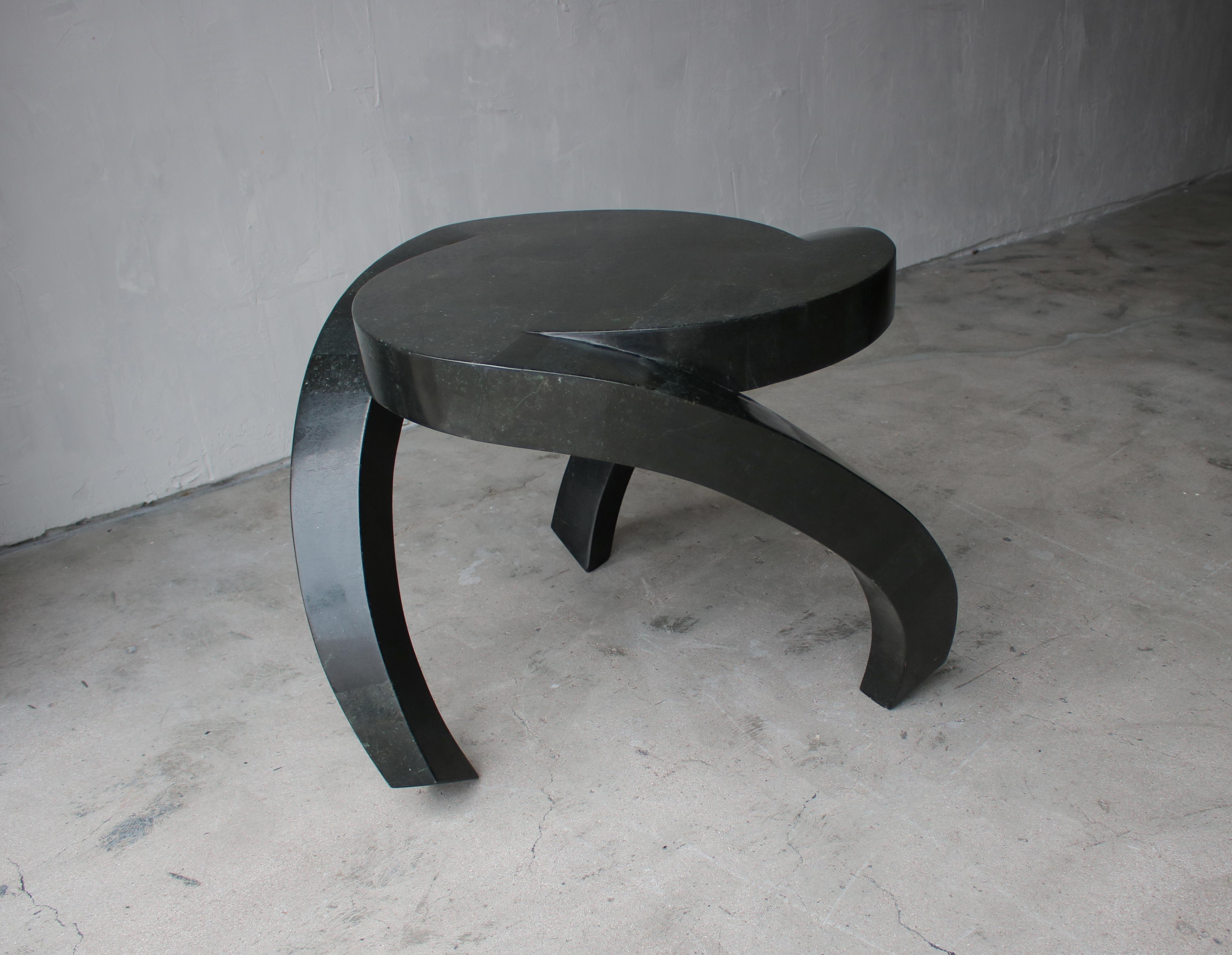 Look at this color. Gorgeous dark emerald green, tessellated stone side table by Maitland-Smith. Table has a very eye-catching, trefoil shape, with three waterfall legs. Very designer, you'll likely never see another like it.

Table is in
