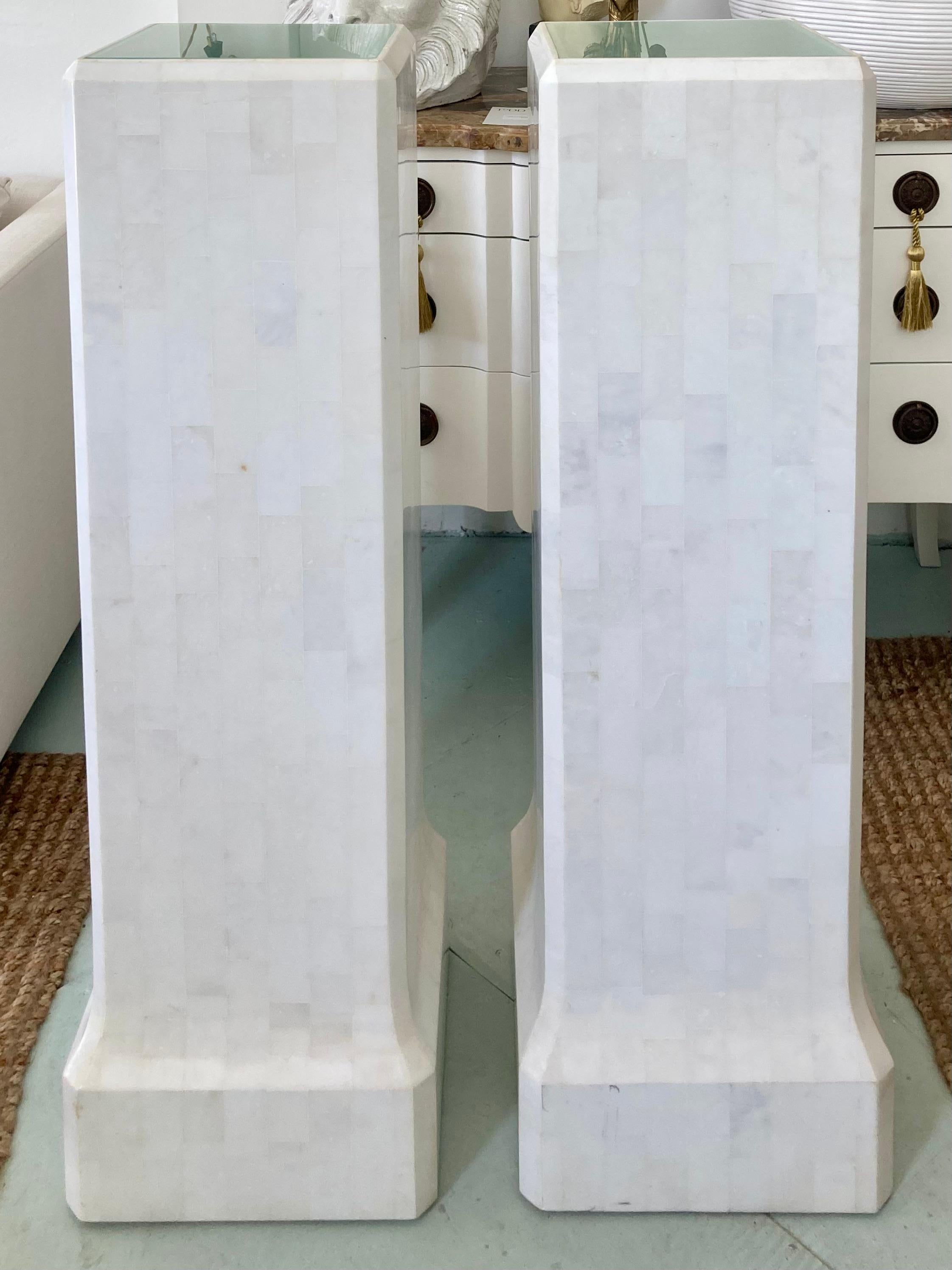 Beautiful pair of tessellated white marble pedestals with lighted surfaces. The detail work of the marble inlay is incredible. The detail at the base with the slightly flared surfaces adds to the design. Both pedestals are light up with electrical