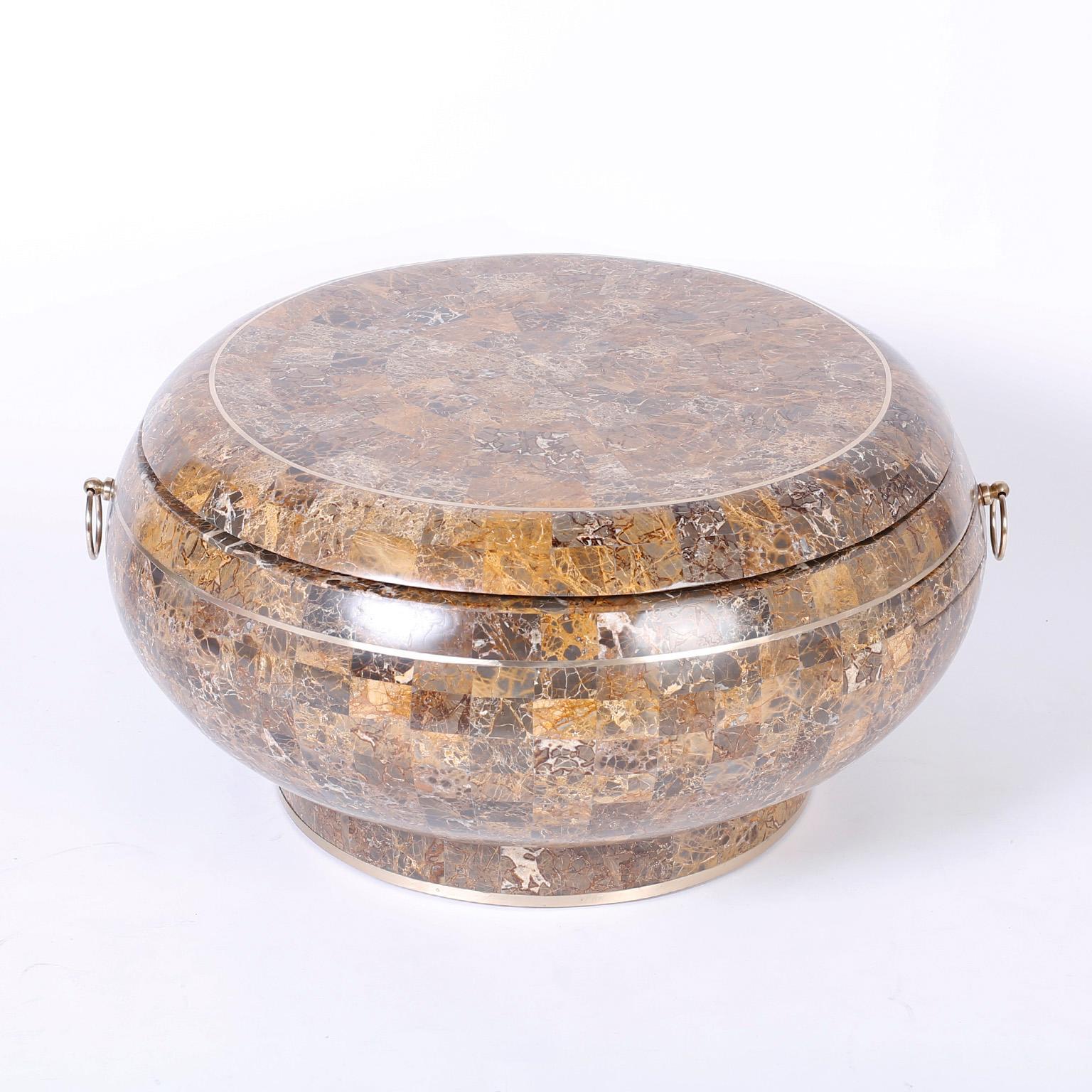 Round coffee or cocktail table with multiple components and ubiquitous appeal. Expertly crafted in wood entirely clad with a tesellated mosaic of stone veneer and trimmed in brass. Featuring swivel and slide out trays. Probably Maitland-Smith.