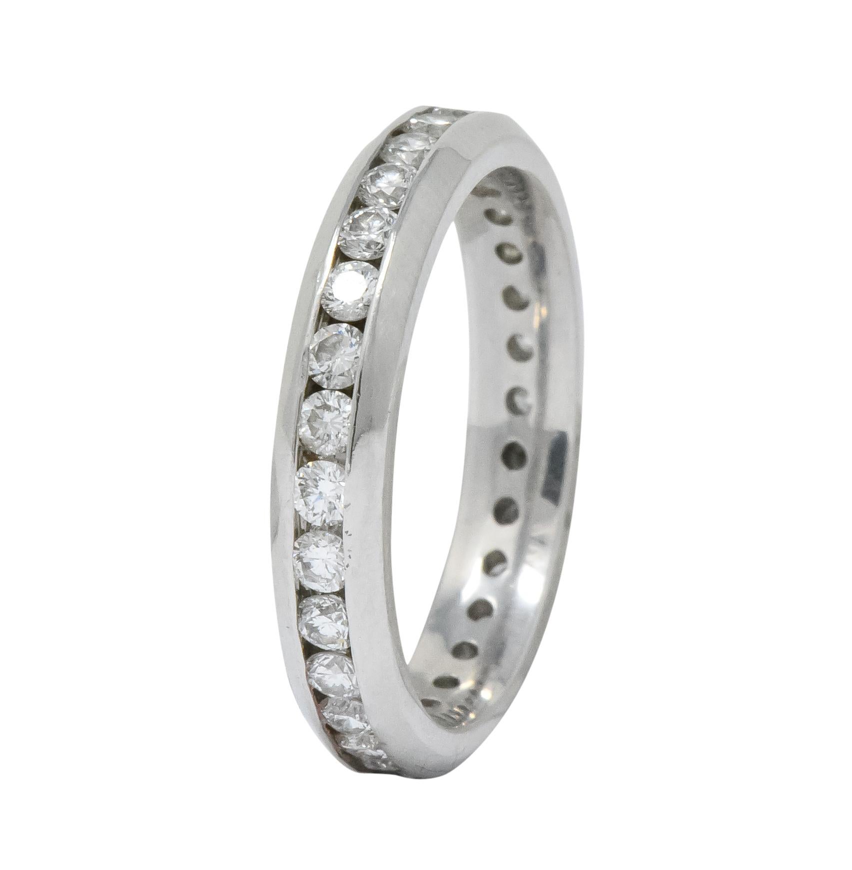  Featuring channel set round brilliant cut diamonds throughout entire band surface weighing approximately 0.60 carat total, H/I color and VS to SI clarity

With high polished finish and channel edges that taper to flat profile edge

Maker's mark for