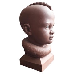 Himba child head carved on red sandstone -made in Italy