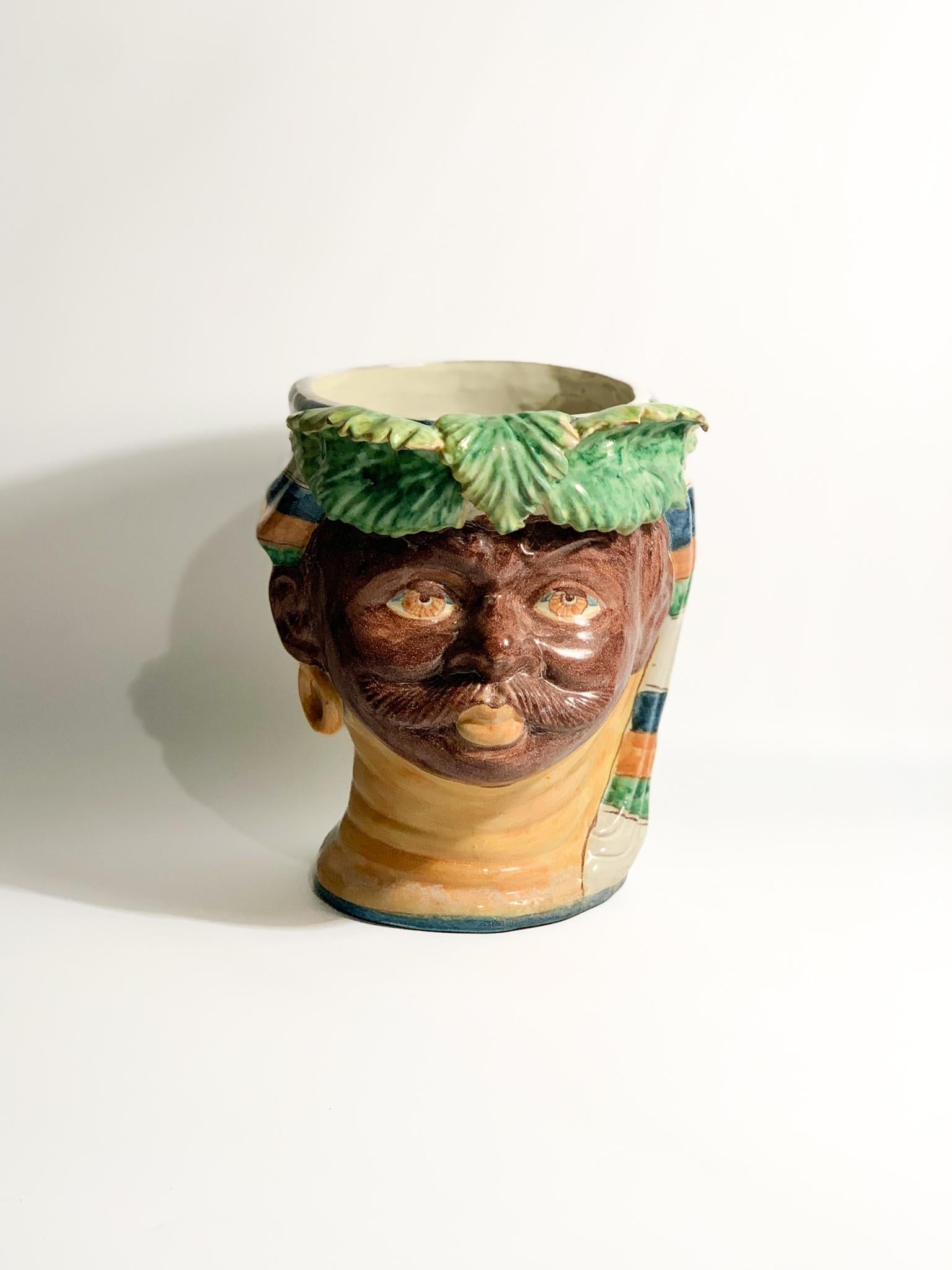 Moor's head in Caltagirone ceramic of a male figure, created by Giacomo Alessi in the 1990s

Ø cm 20 h cm 29

Giacomo Alessi is an Italian master ceramist born in Caltagirone, Sicily, in 1957. He is one of the few registered Sicilian masters in the