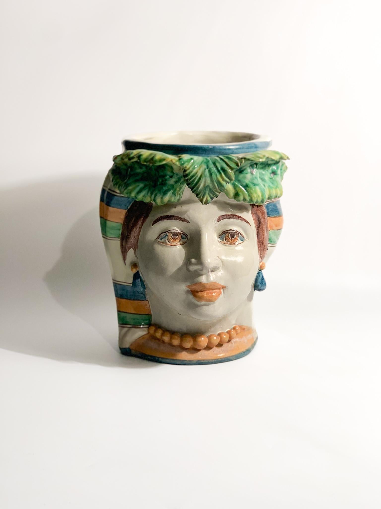 Moor's head in Caltagirone ceramic of a female figure, created by Giacomo Alessi in the 1990s

Ø cm 20 h cm 22

Giacomo Alessi is an Italian master ceramist born in Caltagirone, Sicily, in 1957. He is one of the few registered Sicilian masters in