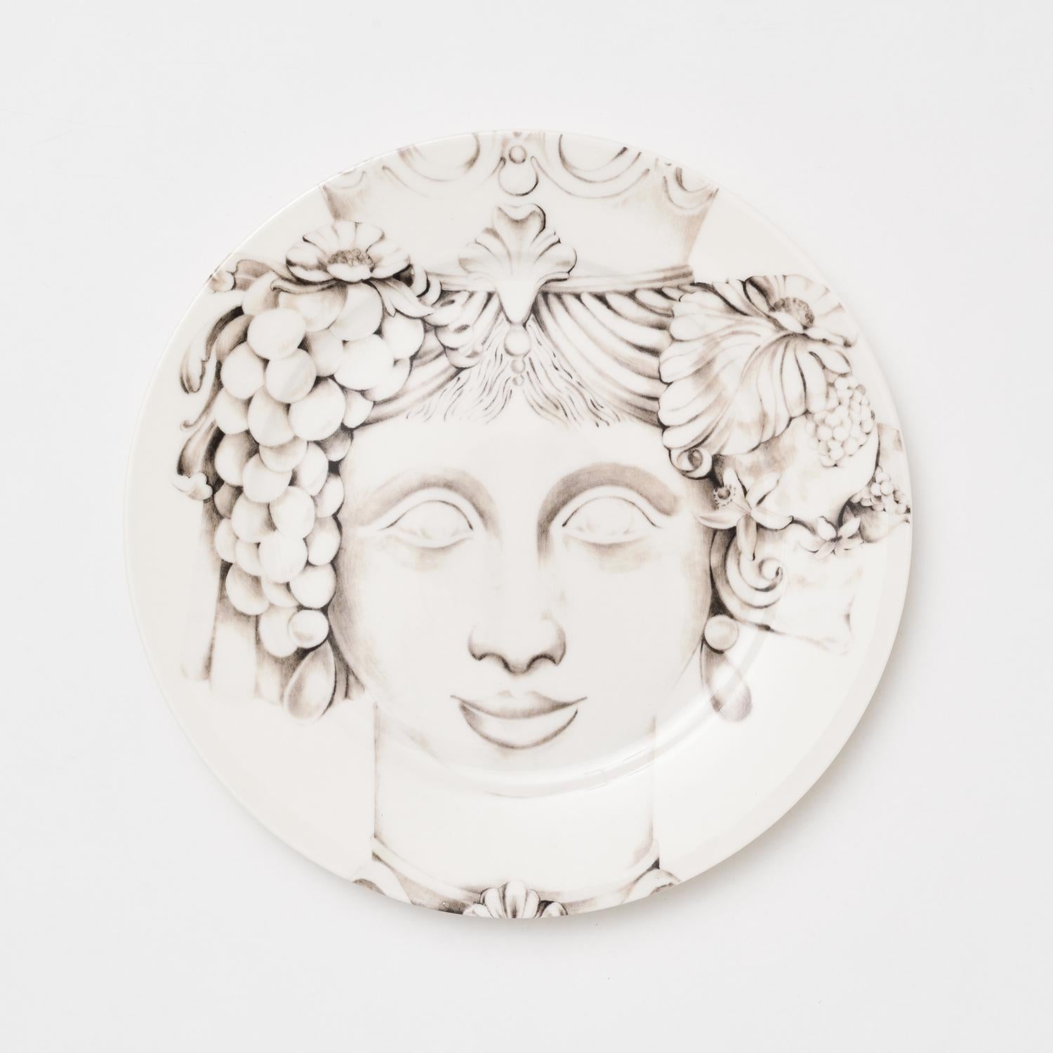 Inspired by the Sicilian Moor's Head tradition, these incredibly detailed Teste di Moro plates are entirely handcrafted in refined porcelain. Showcasing the protagonist's enchanting features in hues of soft grey, this piece will have a sophisticated