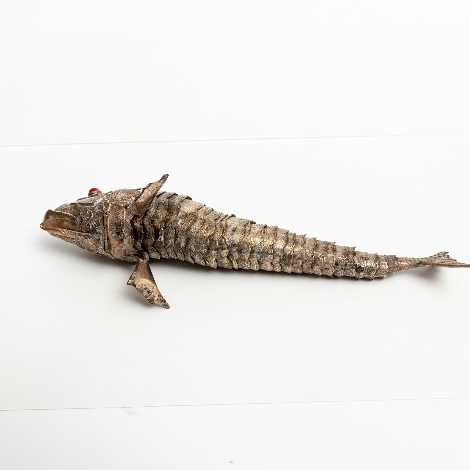 Circa 1920s fish shaped spice box to hold Besamim spices used in the Jewish Havdalah ceremony. The piece is composed of tested 800+ antique silver with articulated body in an s-curve similar to a swimming fish. The head opens on a hinge to dispense