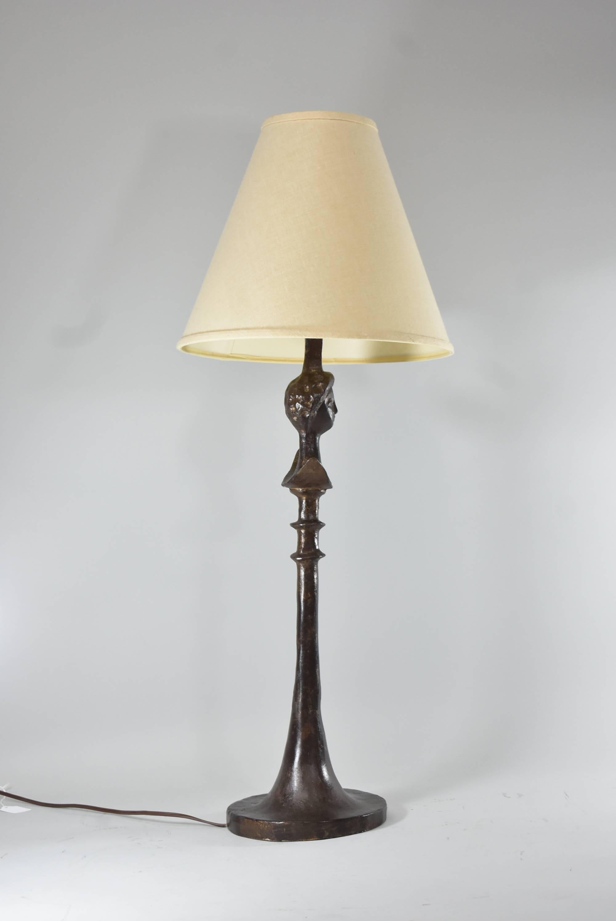Single socket bronze tone Tete De Femme table lamp with figural lady. Design by Giacometti after Arkitektura.