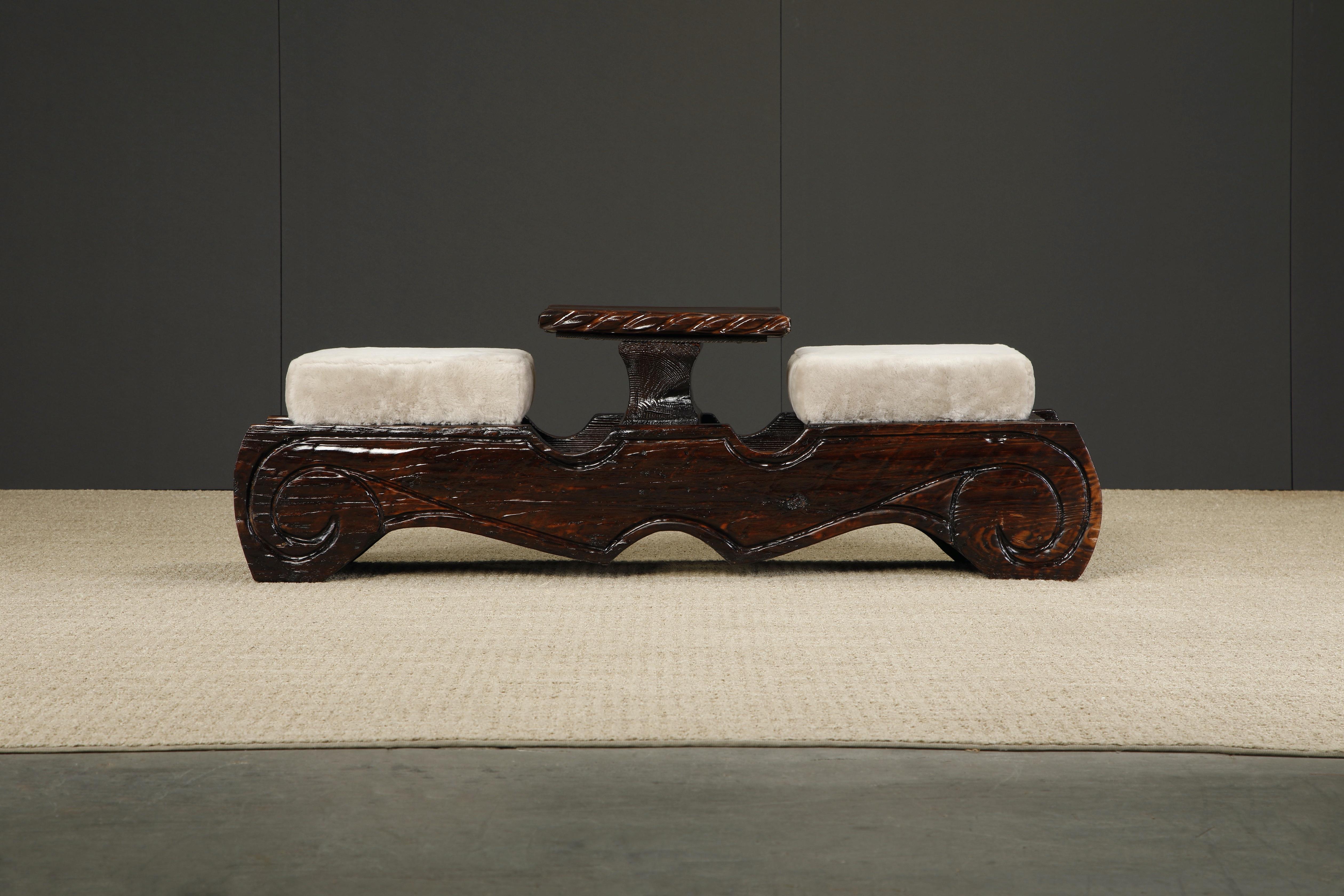 This circa 1950s ornately crafted tête e tête with carved exotic details and soft furry sheepskin are a testament to William Westenhaver's modern rustic creations. Influenced by Polynesian natives sculpting their ancestral deities in to wood
