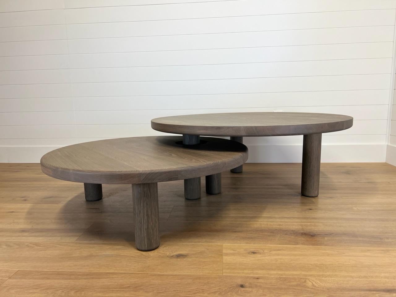 Shown in fumed weathered white oak that will patina over time. Interlocking nesting tables that can be customized in size. hand turned dowel legs.  Price is for the set of 2 tables. . 

44×16 (upper) 36×14 (lower with leg opening)

Available in