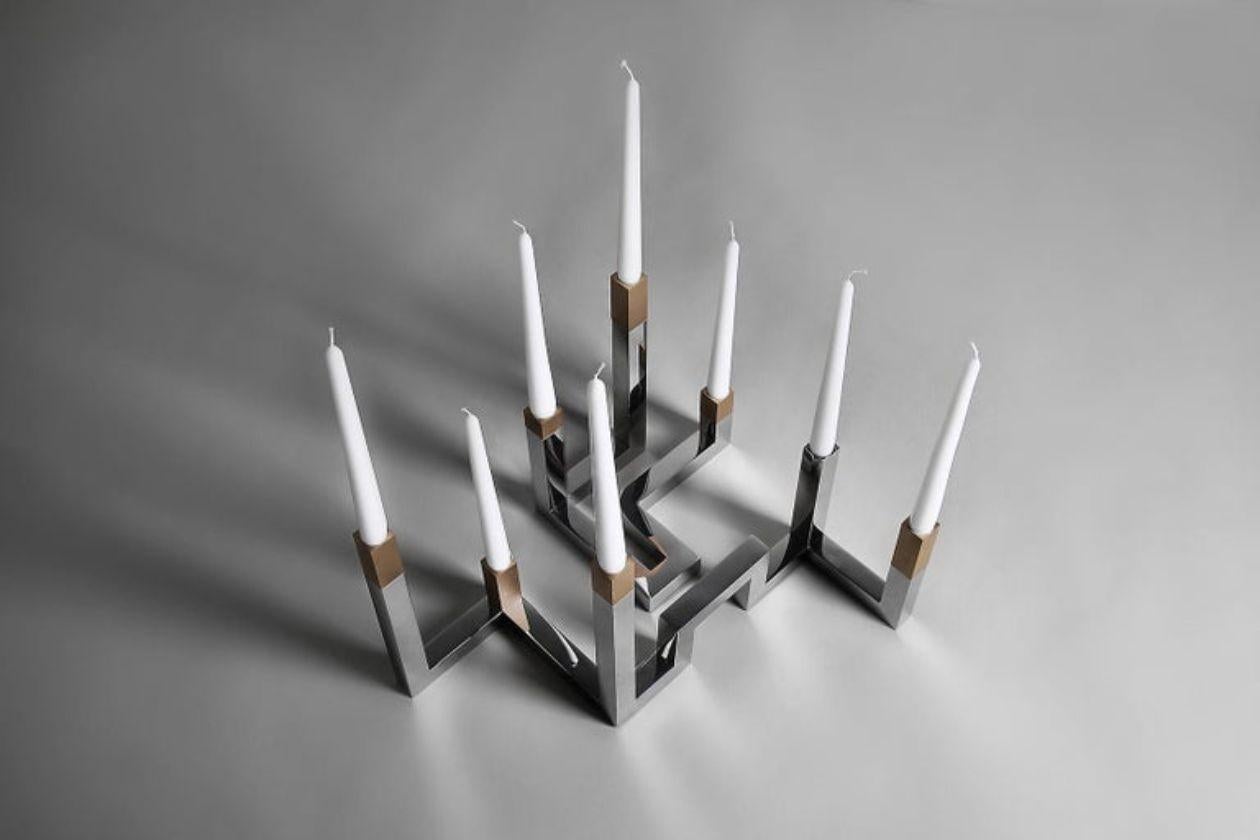 Inspired by the Tetra Line, this large candle holder can be joined with a small one (TETRA - CS) dynamically, allowing many combinations to fit the setting.
Made of Polished stainless steel with brushed light oxidized brass.
Note that the picture