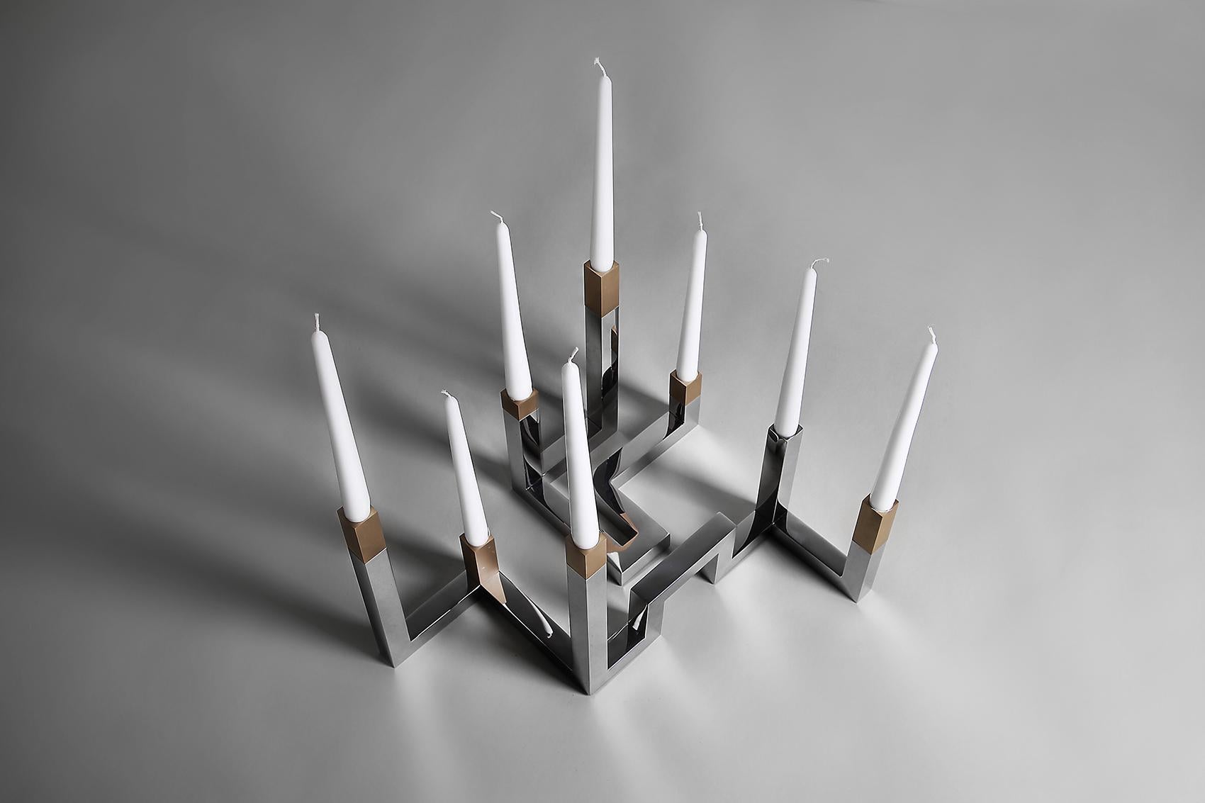 Inspired by the Tetra Line, this small candle holder can be joined with a large one (TETRA - CL) dynamically, allowing many combinations to fit the setting.
Made of Polished stainless steel with brushed light oxidized brass.
Note that the picture