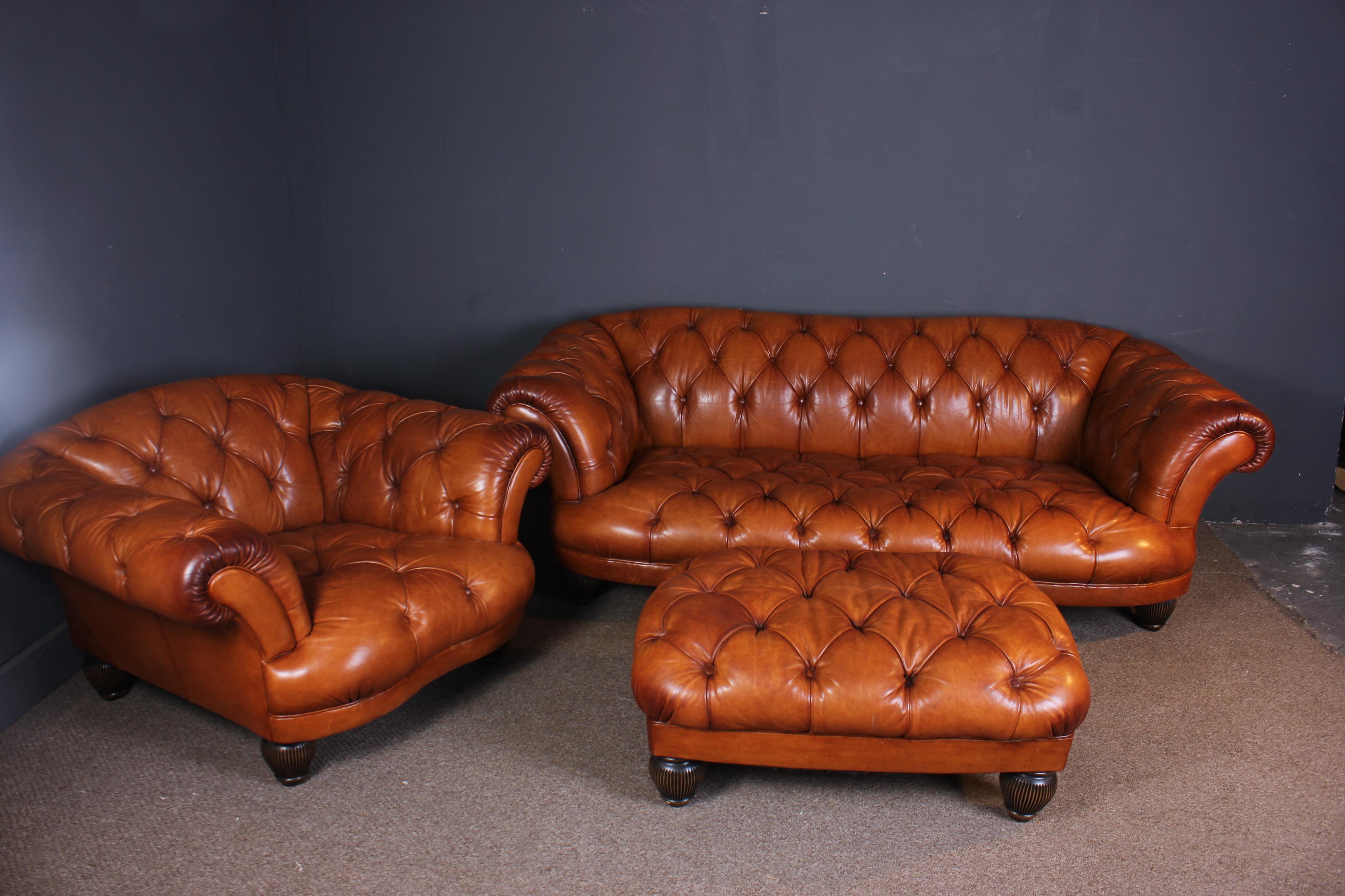 A beautiful superb quality thick leather Chesterfield sofa, armchair and large matching footstool in a stunning caramel brown color. All three items are in very good condition with no rips or tears but do have some age related marks due to use.
