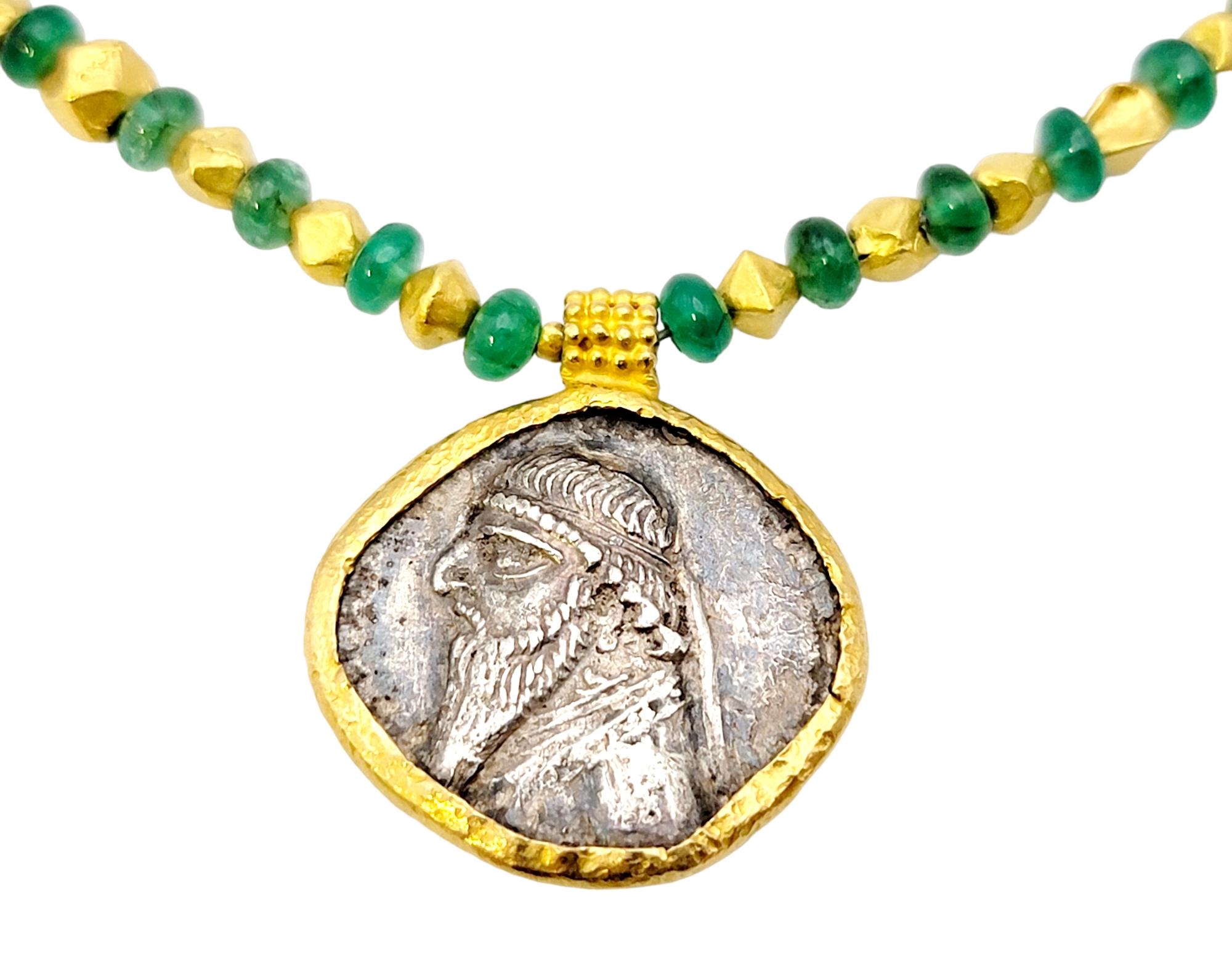 Ancient silver Tetradrachm of Mithridates II coin pendant necklace paired with stunning emerald beads. The impressive coin was created around 109-95 BC and still has its incredible details visible! 

This unique piece features the original silver