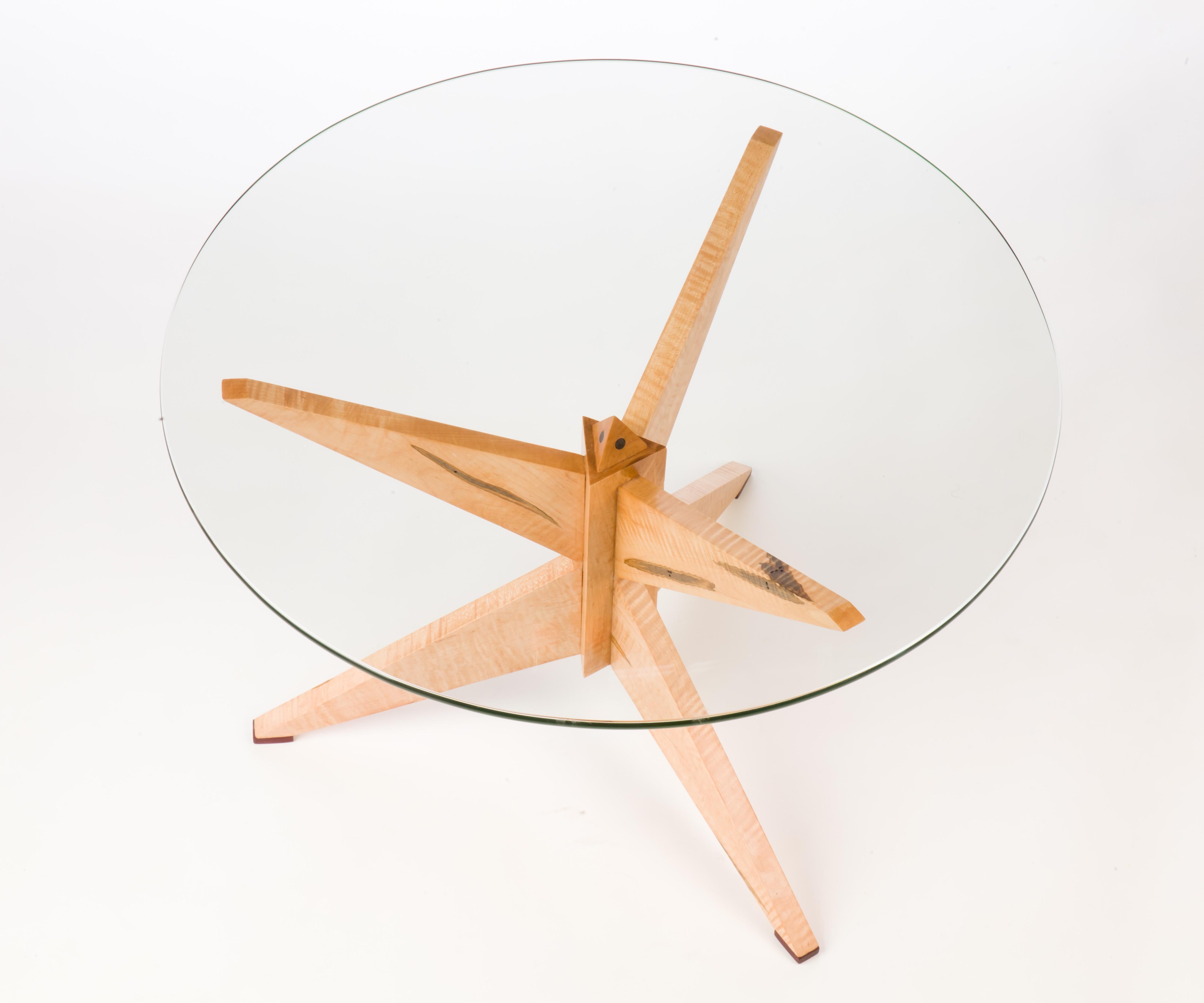 The Curly Maple TetraTeaTable, and its twin, were my first to use sliding dovetails to join their legs. This sublime joinery, and its resultant strength, enable an ample expanse of glass to be at your fingertips while the Tetrahedron, and its third