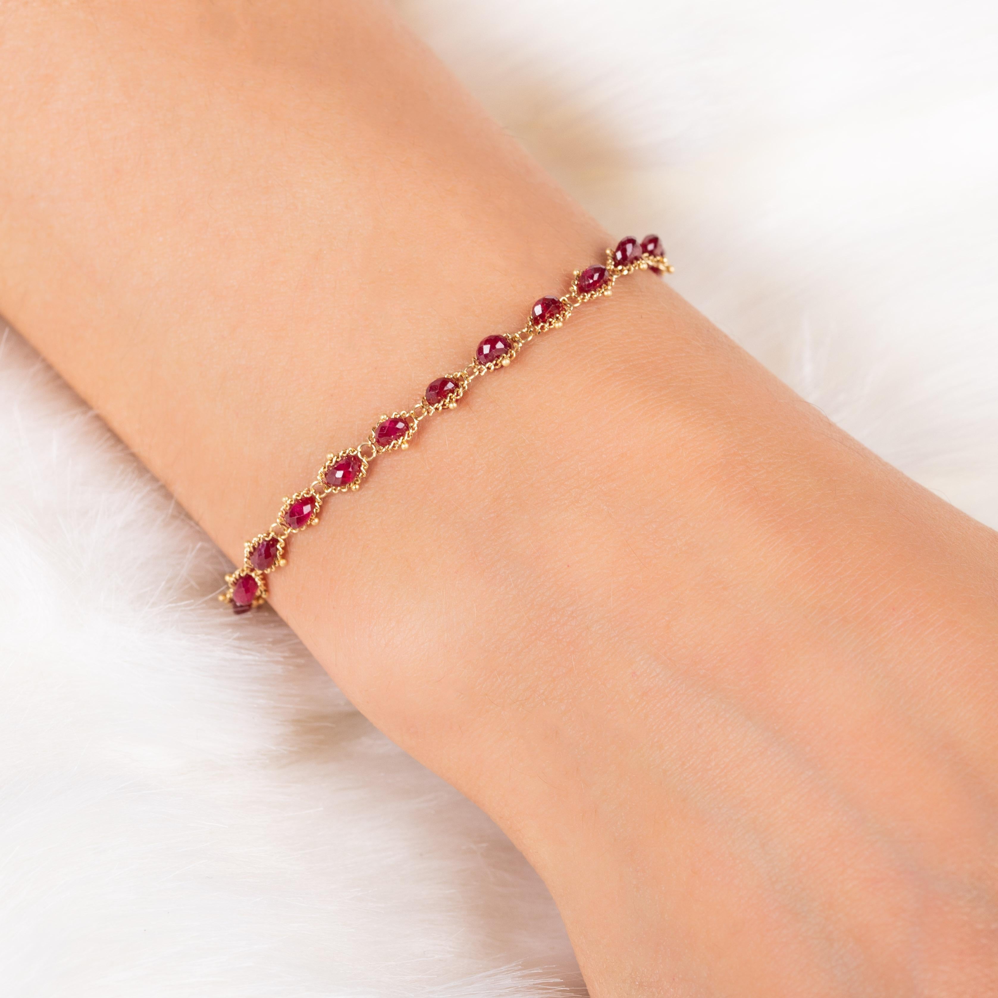 Fiery red Ruby beads light up this luxurious bracelet, which features a parade of beads meticulously hand-woven into a delicate web of 18K yellow gold chain. This bracelet is bold and striking, while still elegant and simplistic.  

Technical