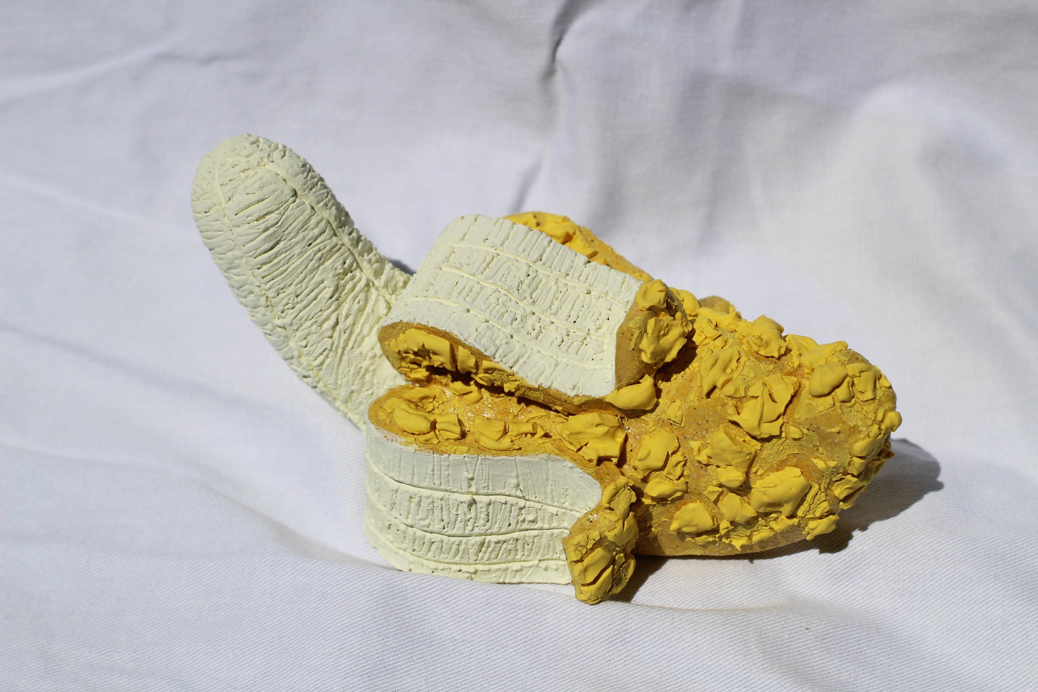 It's yellow and it's annoying?

A banana-na-na-na-na.

But this one is sweet. You can hang this textured banana on the wall. I just won't eat it. But if you want, you can touch it.

Handcrafted texture banana made of ceramics. You can hang it