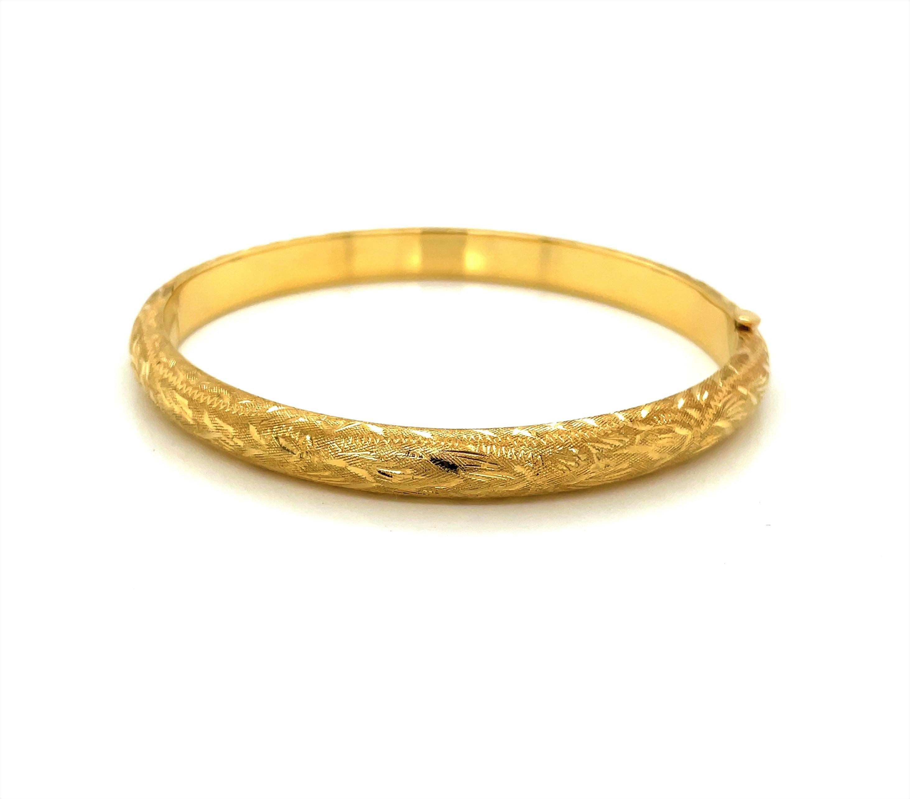 Perfect for every occasion, this essential 14 karat yellow gold bangle bracelet can be worn as a stand alone piece or perhaps stacked to complement other favorites from your jewelry wardrobe. At a modest 6.6 mm width, the textured finished with its