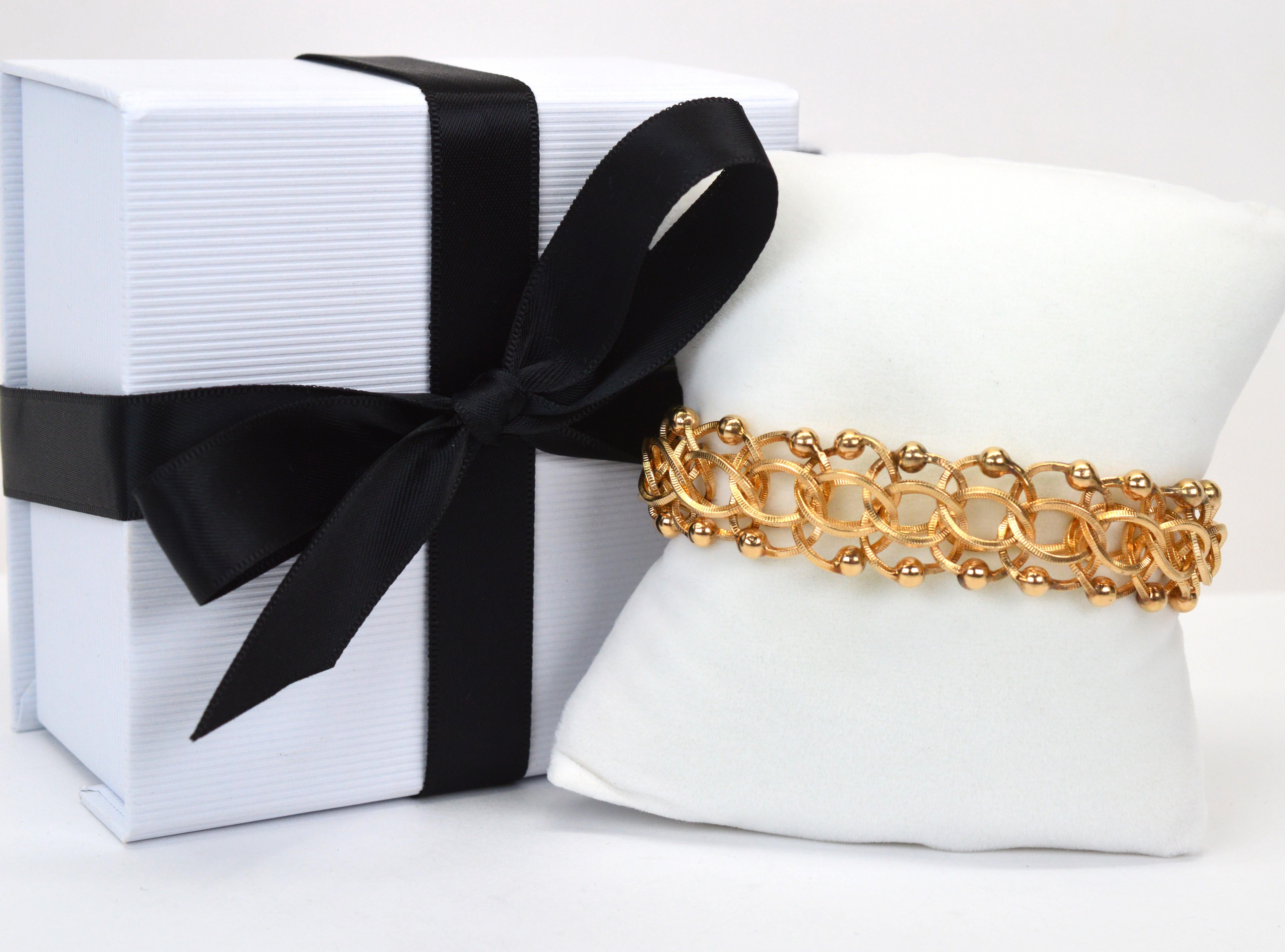 Donna Bracciale a catena aperta a maglie intrecciate in oro giallo 14 kt. in vendita
