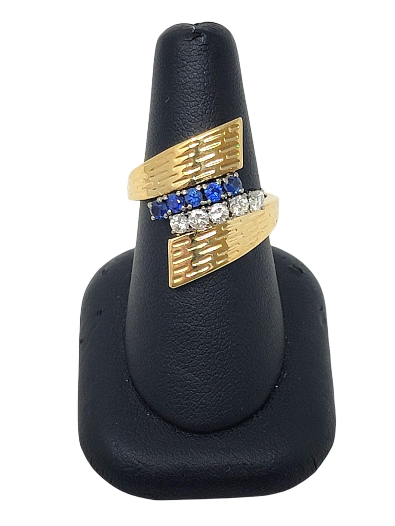 Ring size: 7.25

Contemporary wrap style ring in textured yellow gold accented at the center with natural blue sapphires and icy white diamonds. 

Ring size: 7.25
Metal: 18K Yellow Gold
Weight: 8.40 grams
Natural Sapphires: .35 ctw
Sapphire cut: