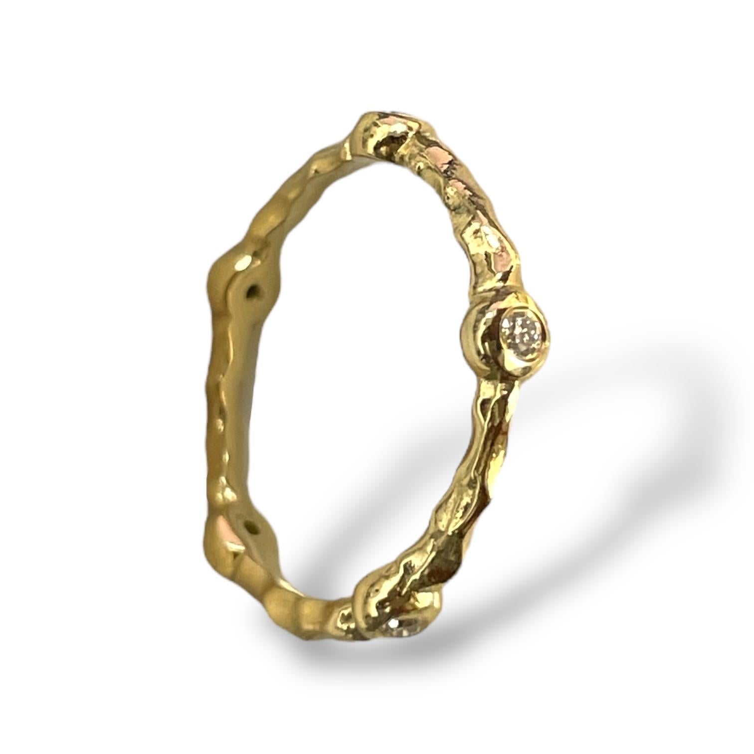 This exquisite 18K gold band features a nature-inspired textured design, beautifully complemented by sparkling diamonds. With its organic, bamboo-like detailing, this ring exudes timeless elegance and sophistication. Perfect as a wedding band or a