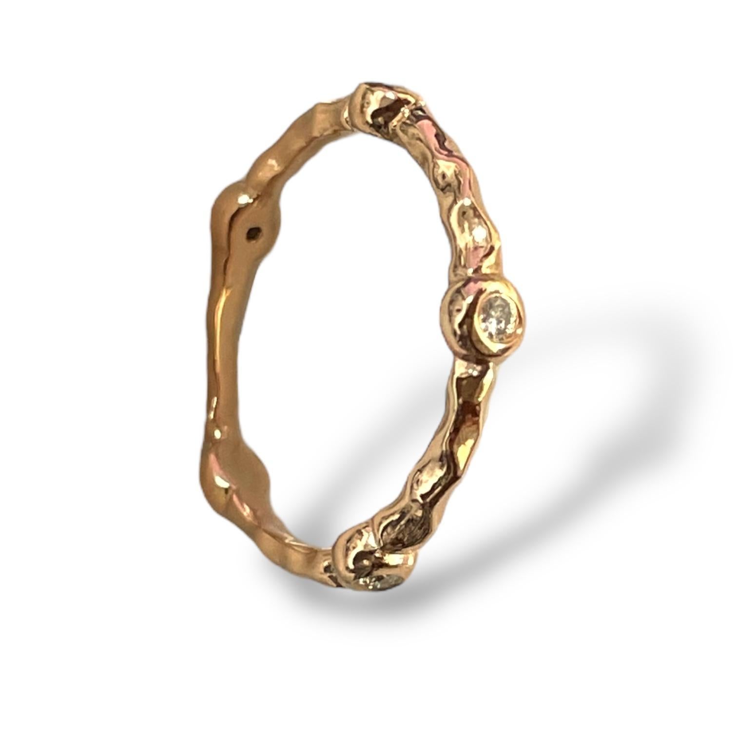 This exquisite 18K gold band features a nature-inspired textured design, beautifully complemented by sparkling diamonds. With its organic, bamboo-like detailing, this ring exudes timeless elegance and sophistication. Perfect as a wedding band or a