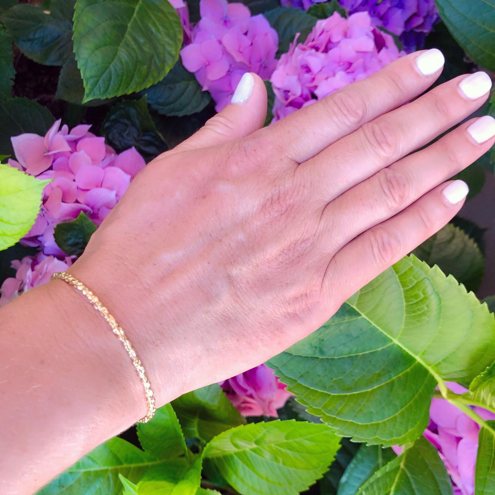 This 18k rose gold bangle bracelet is designed with a hand-cut texture that glimmers. The bracelet fits wrist size of 7.5 inches, and weighs 11.7 grams. Wear alone or stack with other bangles!