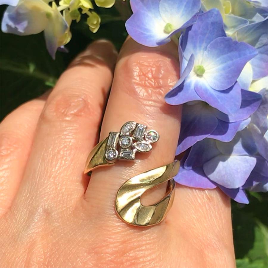 Keiko Mita’s Marlene Ring, which at its widest point is 24 mm, is handmade from 18 Karat yellow gold and multi-shaped diamonds (0.29 carats) set in 18 Karat palladium white gold. The artist’s signature Sand Dune pattern runs all the way around the