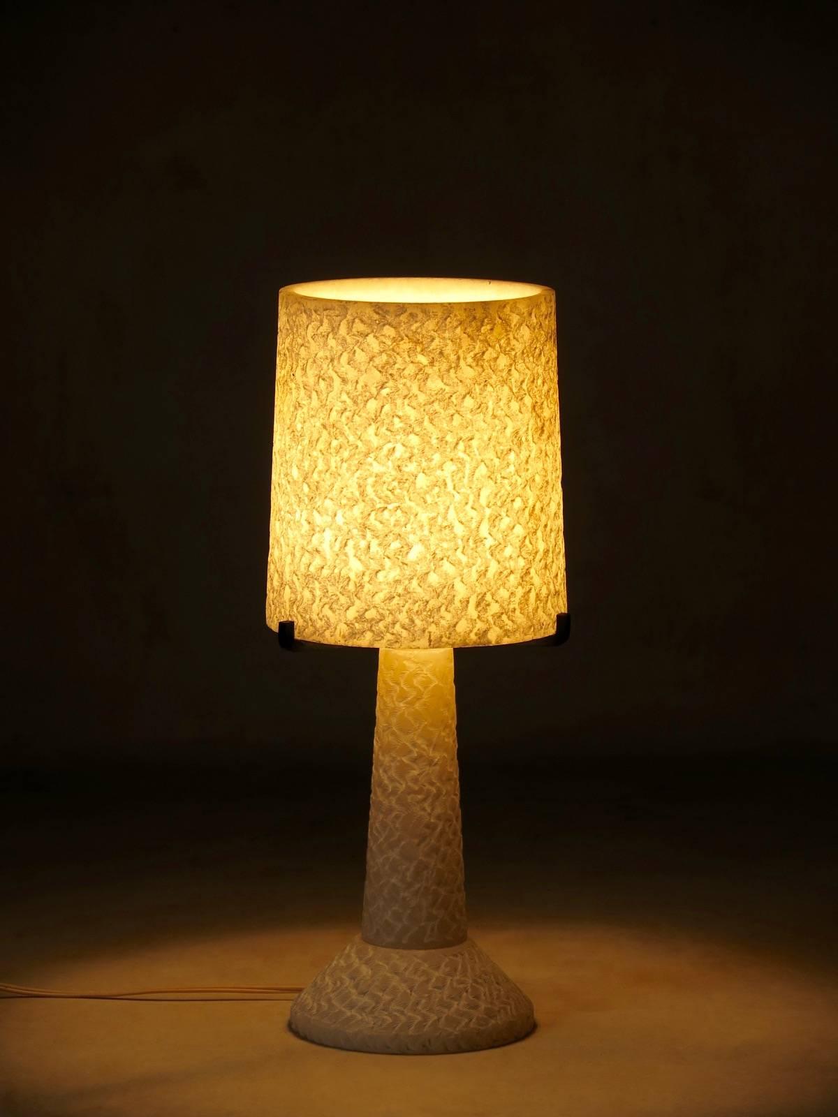 Very lovely alabaster lamp with a heavily textured finish, of elegant, minimalist design. Gives off a very appealing, warm glow when lit.