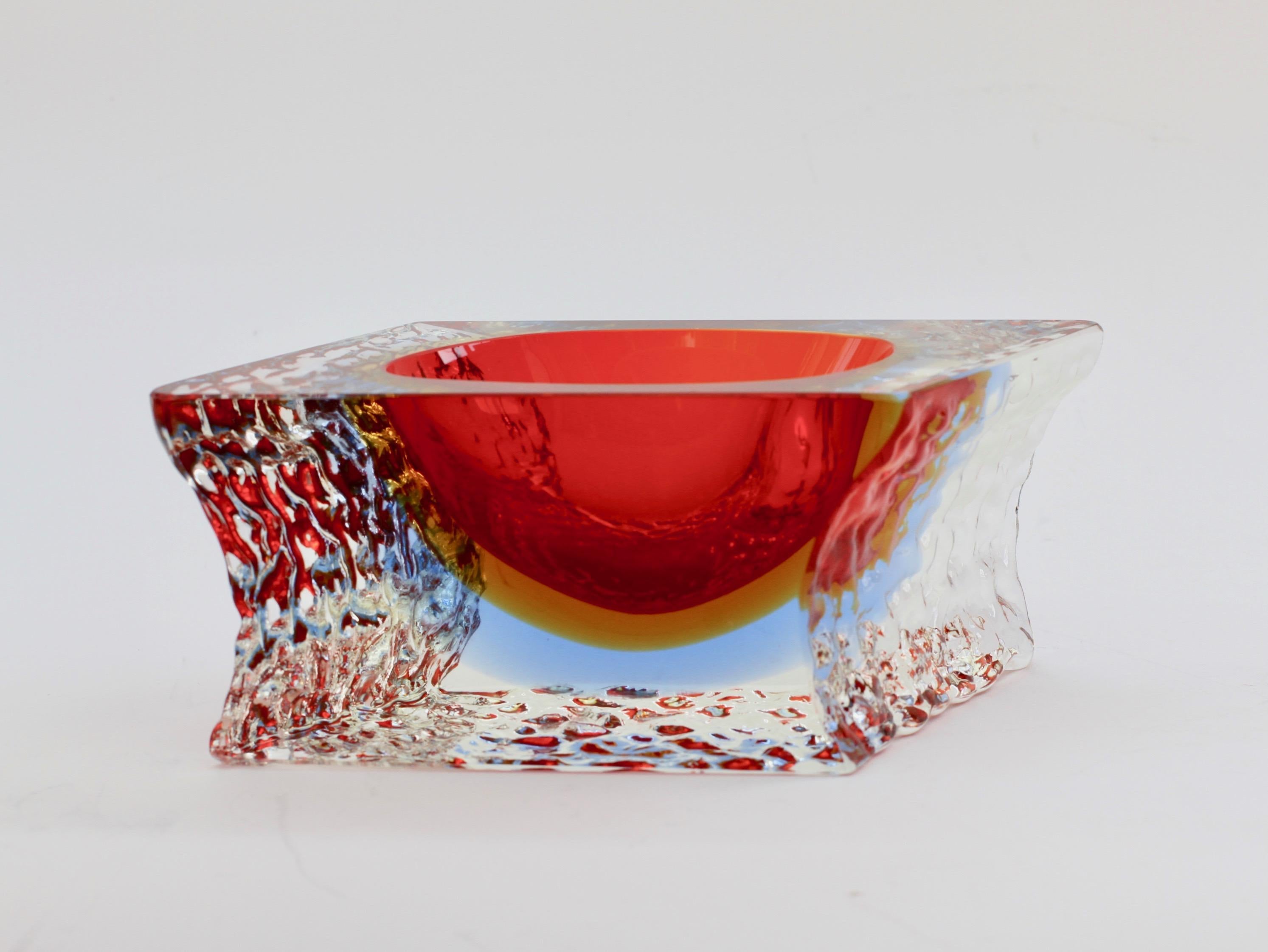 Beautiful made in Italy vintage Mid-Century Modern Venetian, Italian Murano art glass bowl, dish or ashtray attributed to Mandruzzato, circa 1960s-1970s. The combination of ruby red over ochre yellow over sky blue with the textured clear 'Sommerso'