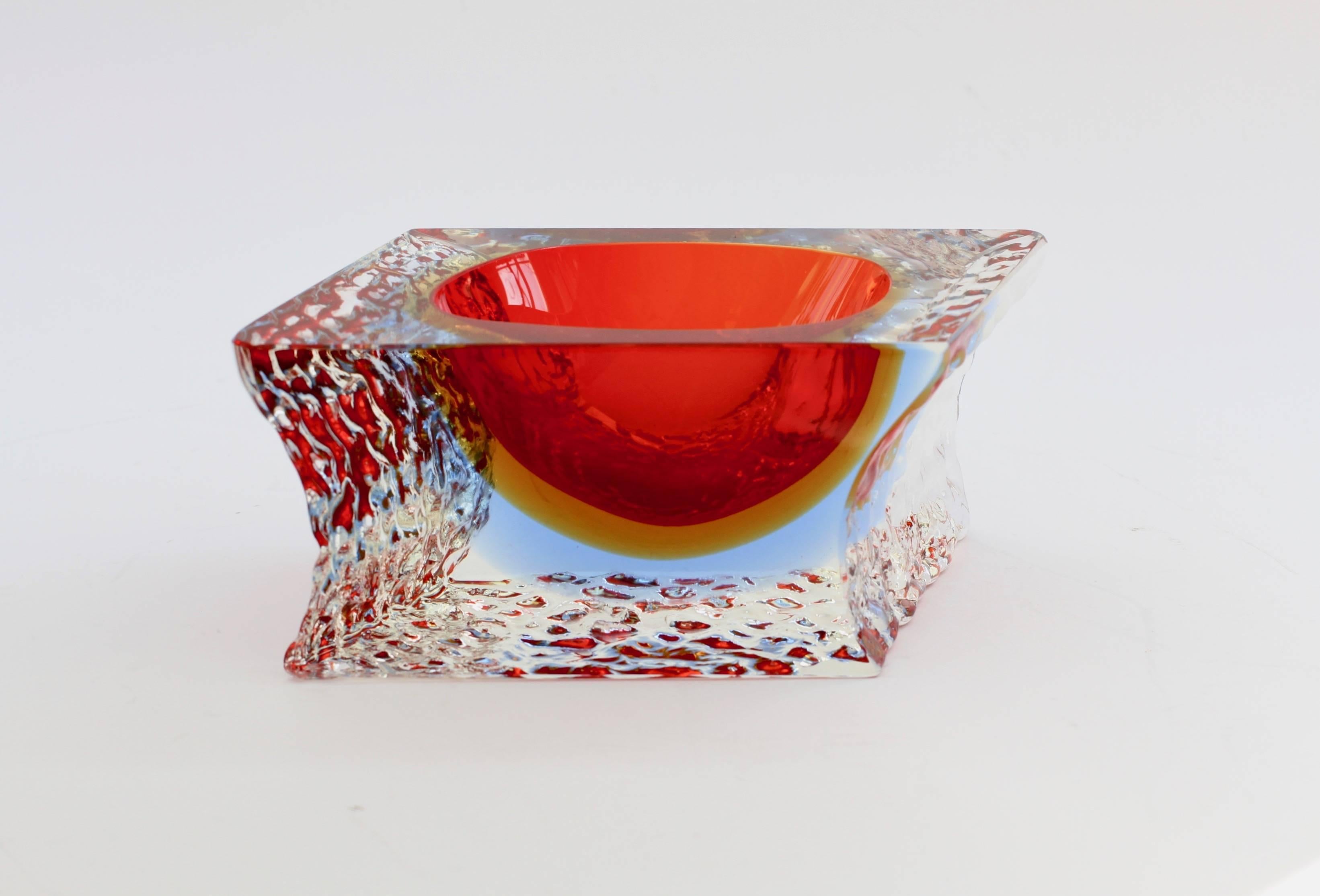 Beautiful vintage Mid-Century Italian Murano art glass bowl, dish or ashtray attributed to Mandruzzato, circa 1980s. The combination of ruby red over ochre yellow over sky blue with the textured clear 'Sommerso' ice glass looks simply stunning.