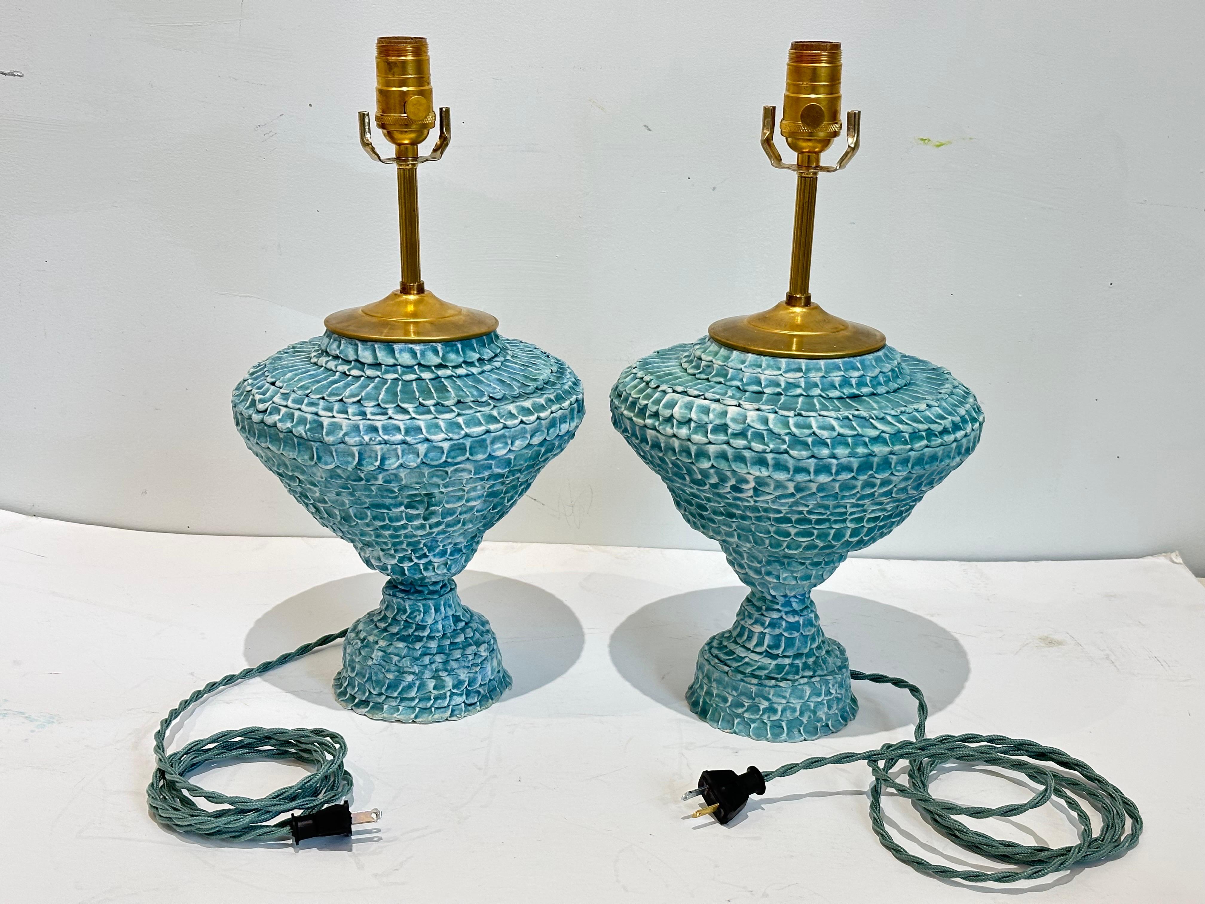 Hand built ceramic urn form lamps in turquoise. Textured surface with variable turquoise to turquoise-green in a matte waxed finish.  All hardware is live brass.  
Ceramic body is 10