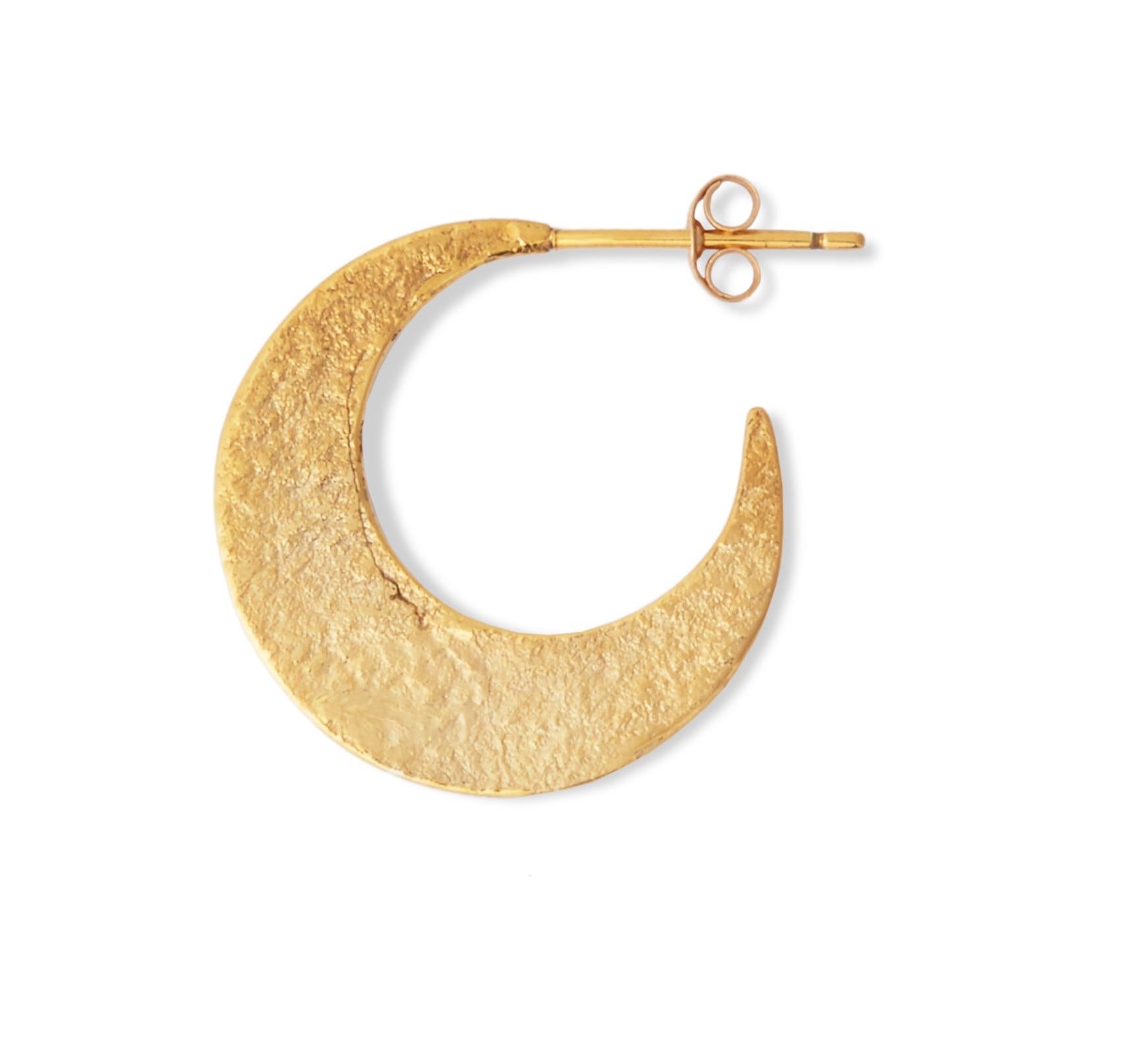 These textured crescent-shaped hoop earrings by Allison Bryan are handcrafted in 18-carat gold plated sterling silver with a post and butterfly closure.  They feature a shimmering texture on one side and a rustic high-polish finish on the other so