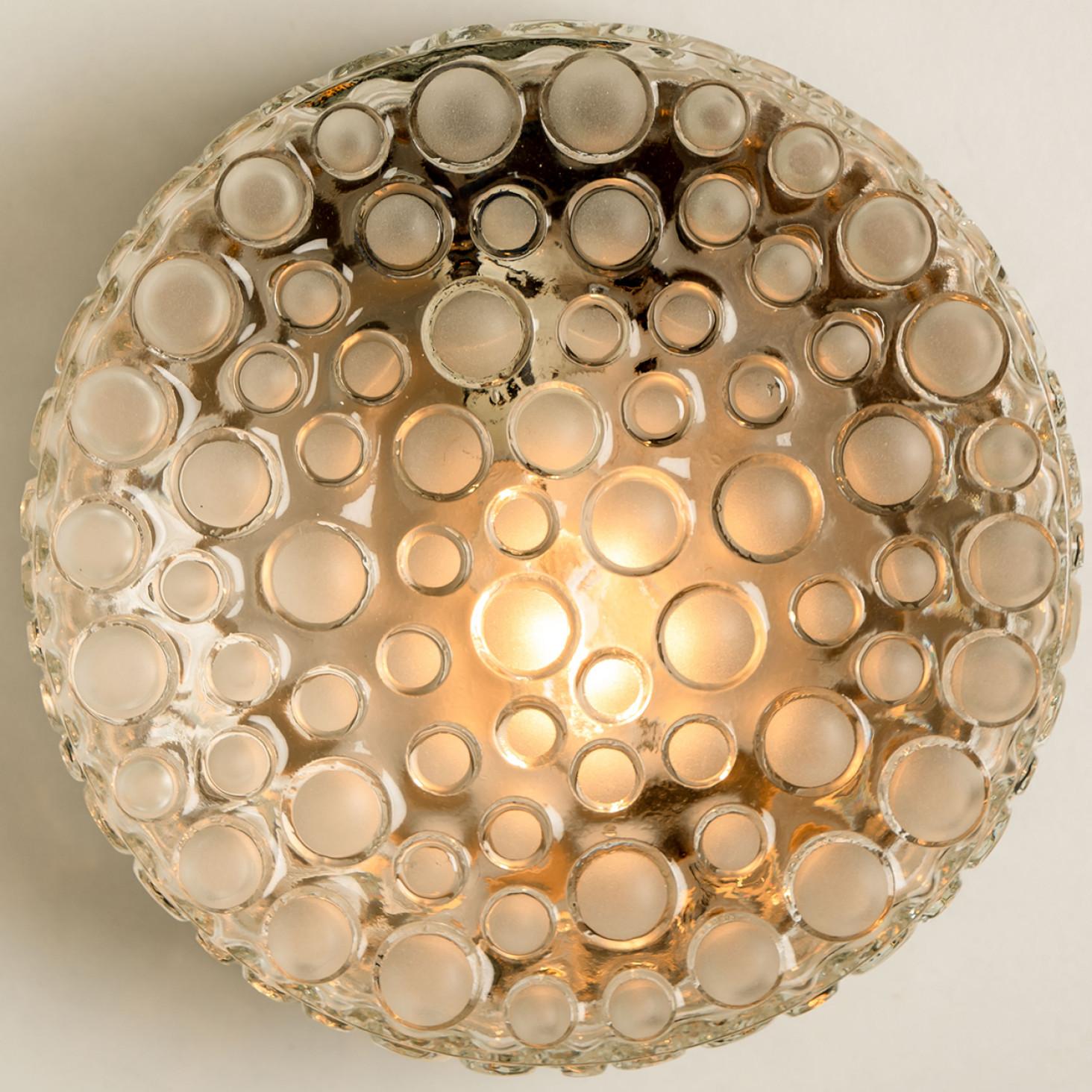 A handmade high quality light fixture made by Hillebrand, Germany, manufactured in the mid century, circa 1960 (at the end of 1960s and beginning of 1970s).

This flushmount or ceiling light features think textured dotted glass.
The texture refract