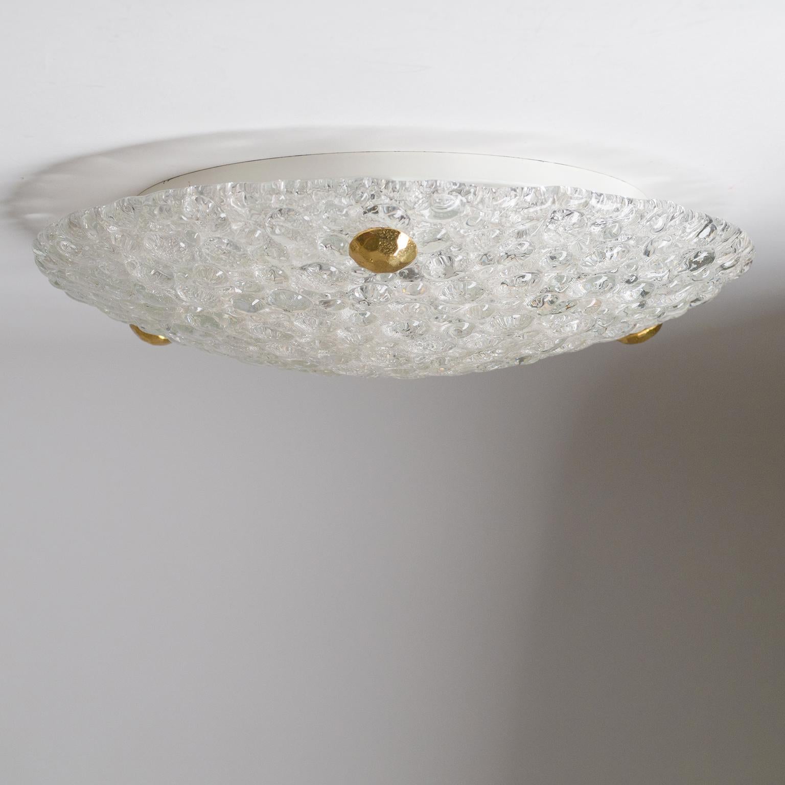 Fine flush mount by Hillebrand with thick bubble-textured glass. Three large sculpted brass knobs affix the glass to a white lacquered back plate which holds three E14 ceramic sockets as well as a manufacturers label. Would also make for an