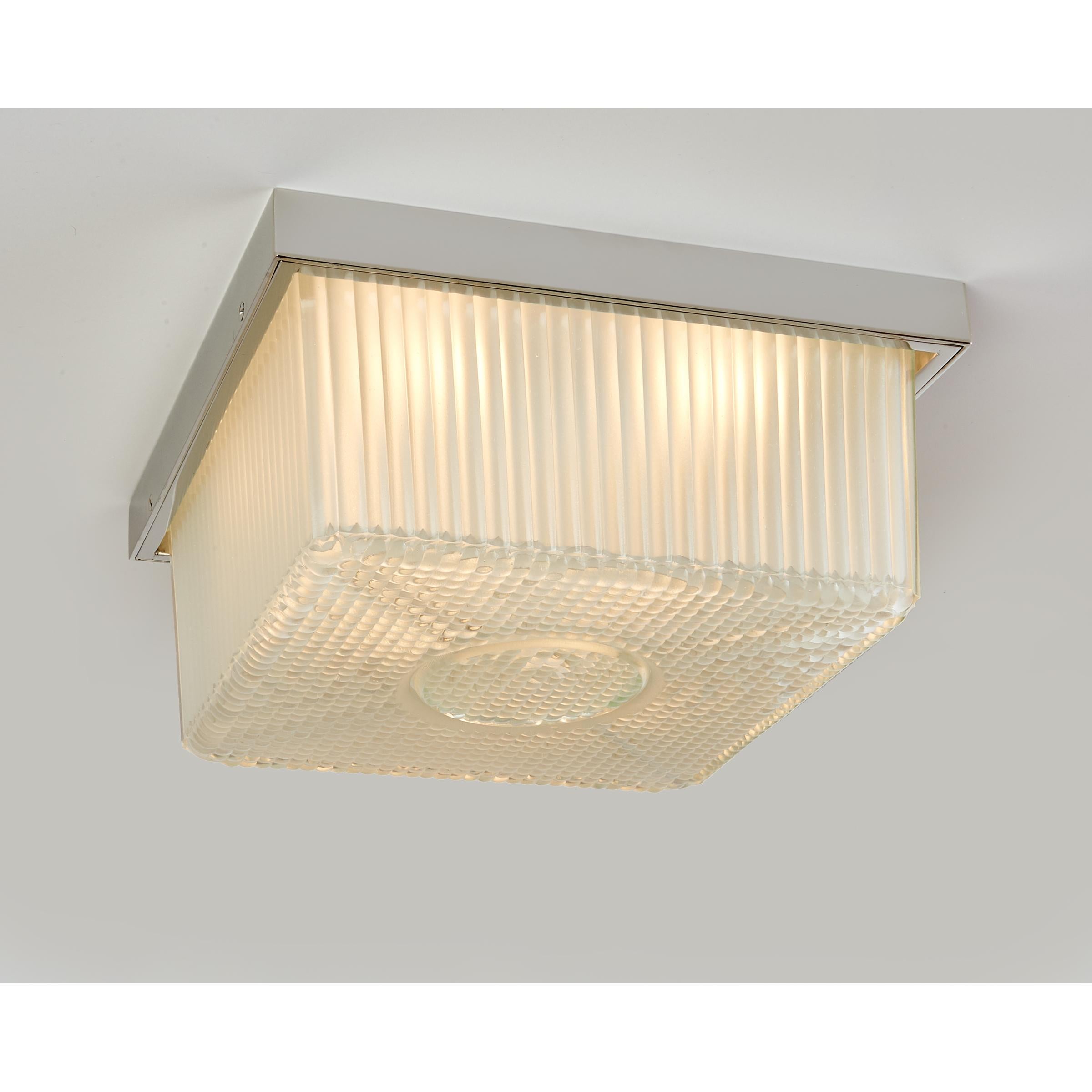 France, 1950s
A square ceiling light in rich ribbed and textured frosted cast glass, 
with ingenious removable center hole opening. Nickeled metal frame.
Measures: 11 W x 11 D x 6 H 
Rewired for use in the US with four candelabra base bulbs.