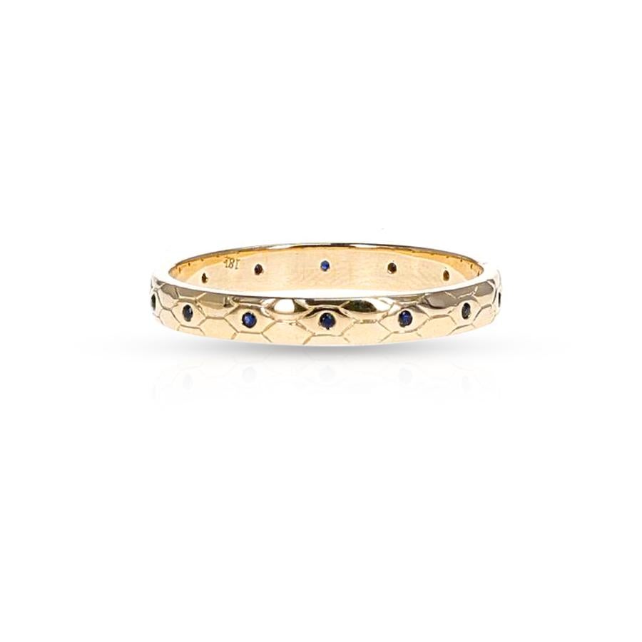 A Textured Gold Band with Sapphires made in 18 karat yellow gold. The total weight of the sapphires is 0.07 carats. The total weight of the ring is 2.23 grams.


