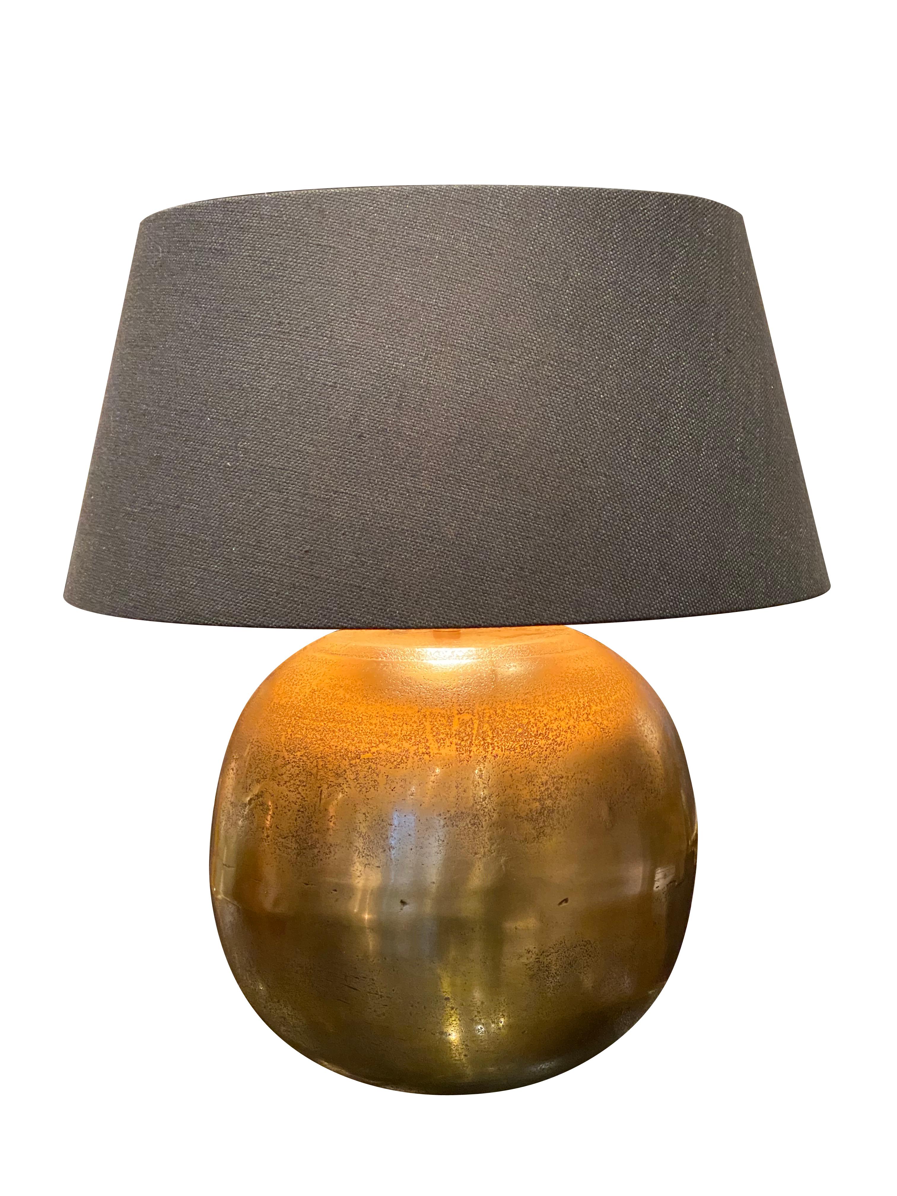 Contemporary Chinese pair of globe shaped lamps.
Textured and mottled gold color made of metal.
Belgian black linen shades with gold interior.
Base of lamp measures 11